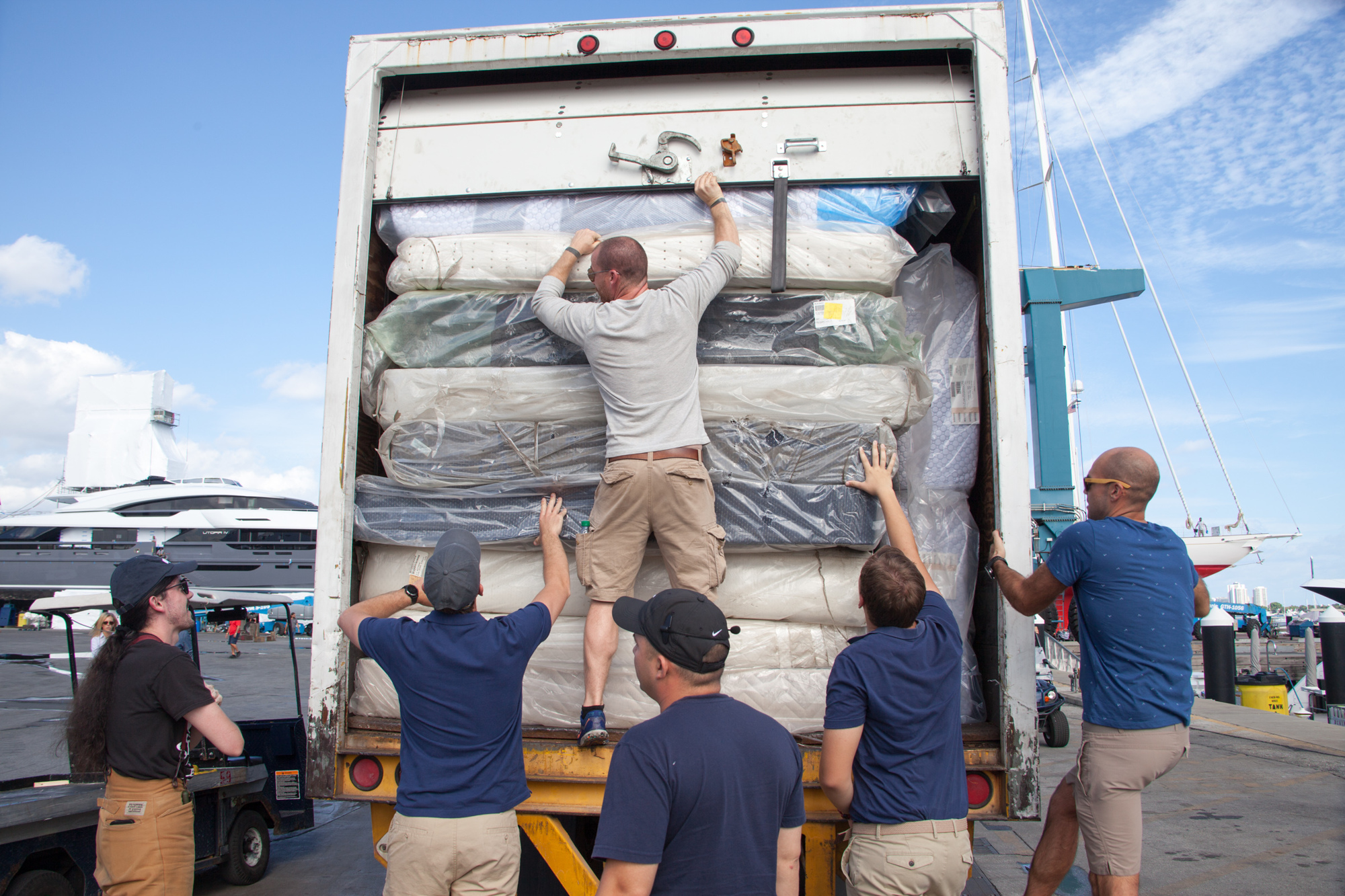 Several Hope Fleet volunteers unload mattresses to give to locals. Photo courtesy