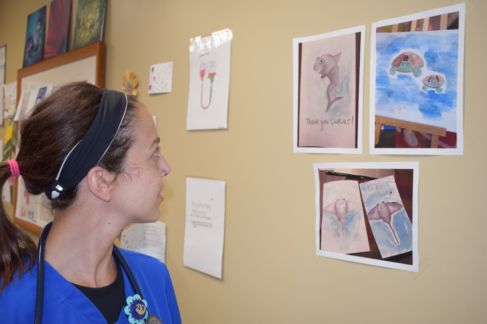 Nikki Mattern, a registered nurse in the ICU at Lakewood Ranch Medical Center, checks out the paintings in the hospital's Inspiration Station.