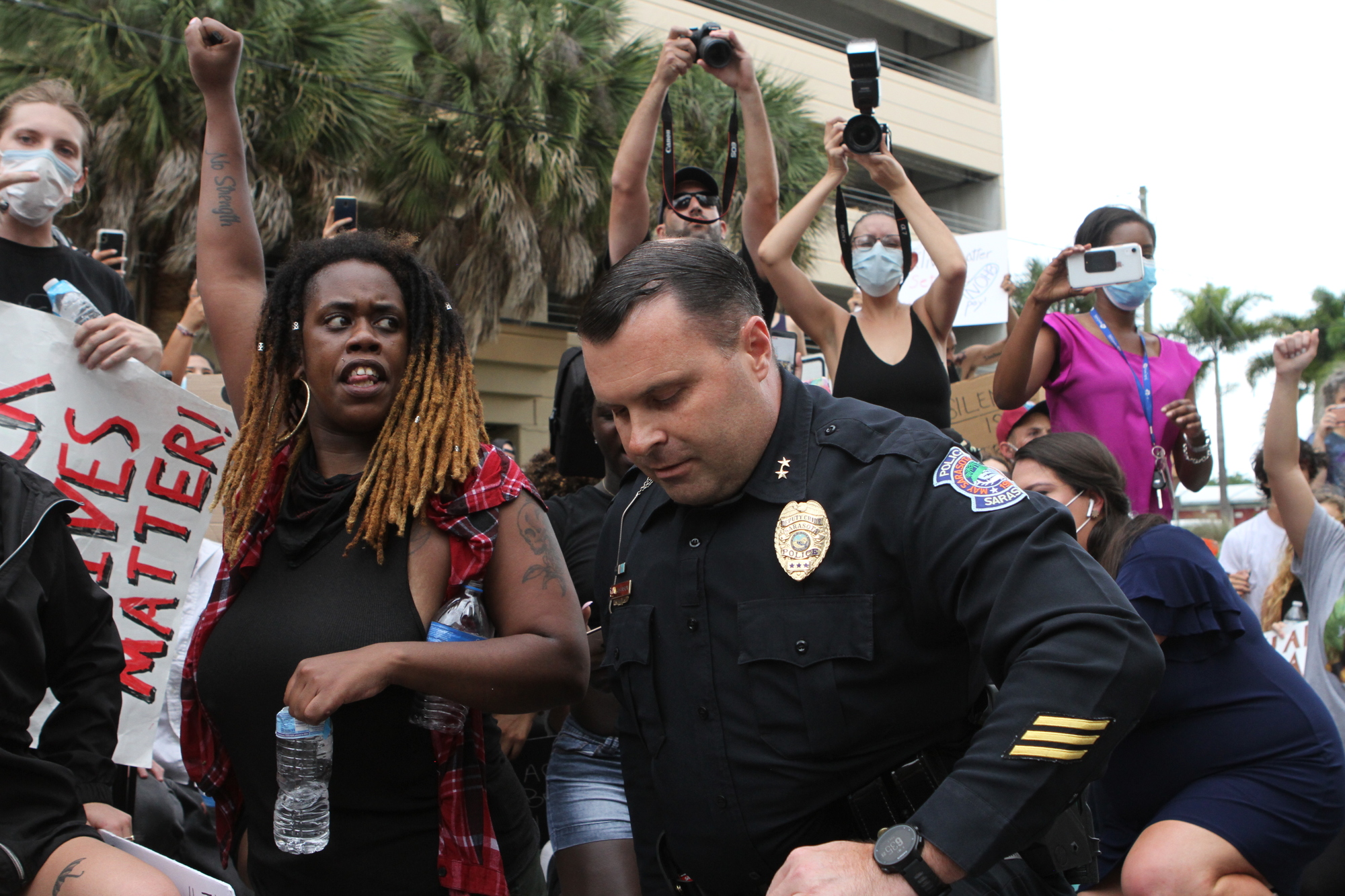 Deputy Police Chief Pat Robinson took a knee alongside protesters during a demonstration outside the Sarasota Police Station Tuesday, June 2. The police department has said it takes pride in its community engagement efforts.
