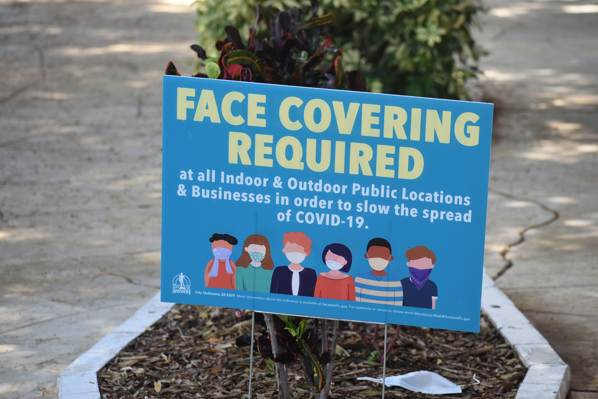 Signs around St. Armands Circle remind folks to wear masks.