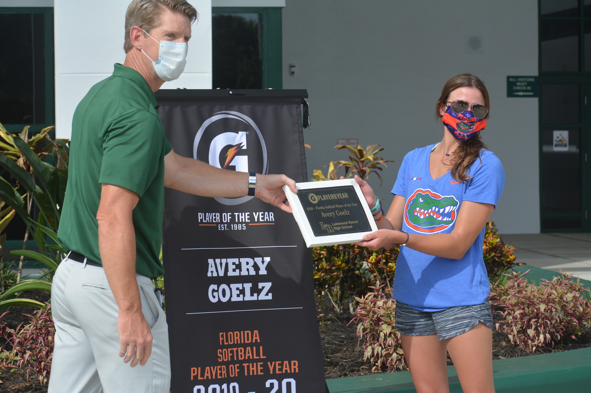 Kent Ringquist presents Avery Goelz with a 2020 Gatorade Florida Softball Player of the Year plaque on Tuesday.