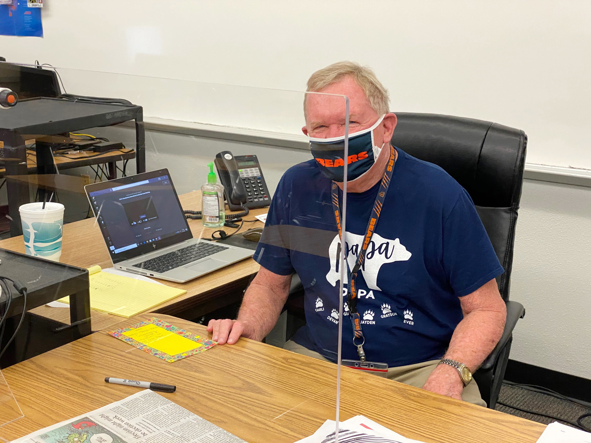 Glen Dallman, a math teacher at Braden River Middle School, sits at his desk with a divider separating him from others. Courtesy photo.