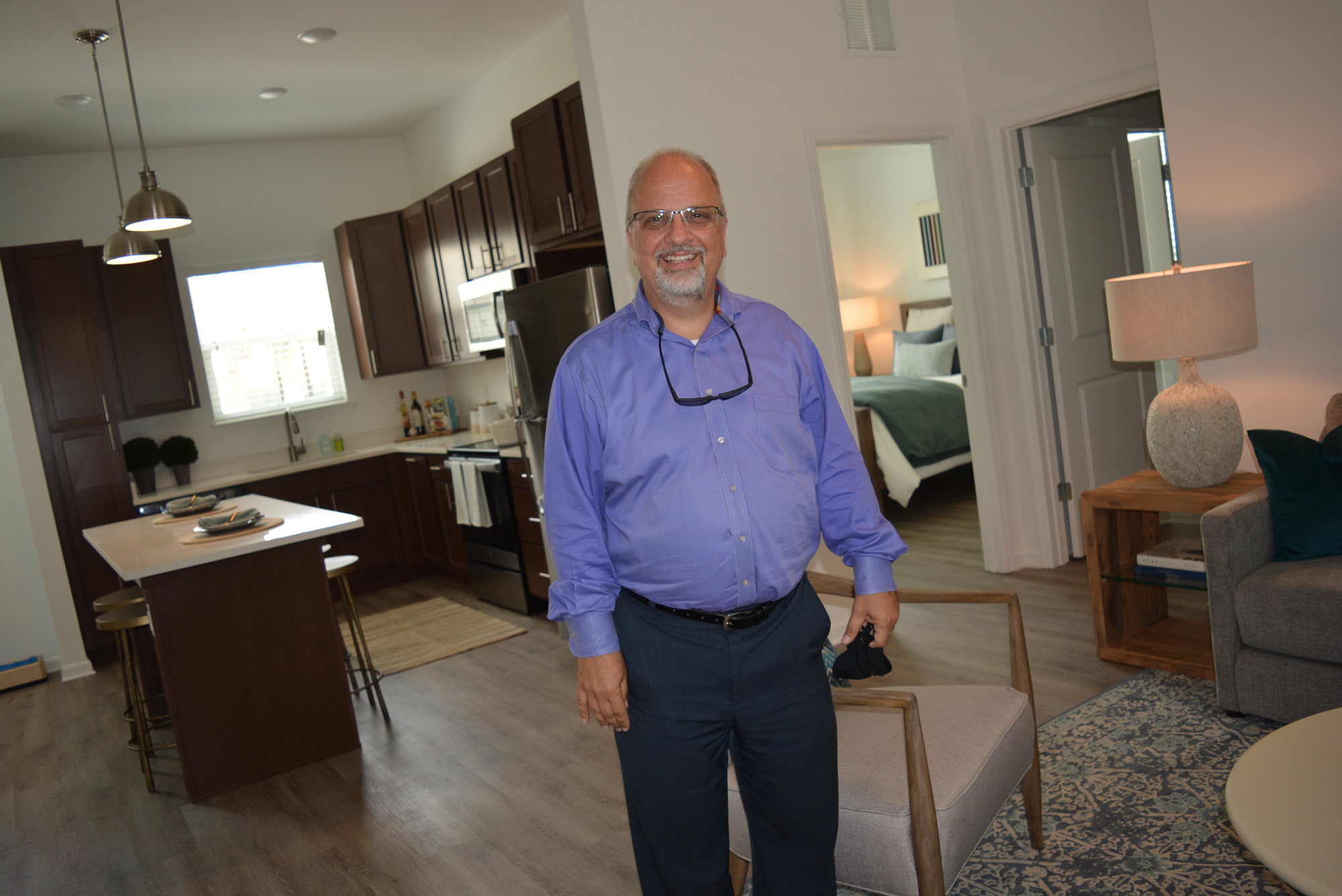 Vincent Ascioti, business manager for the complex, shows off one of the units, which became available for touring Aug. 14.  Each unit has its own private fenced backyard.
