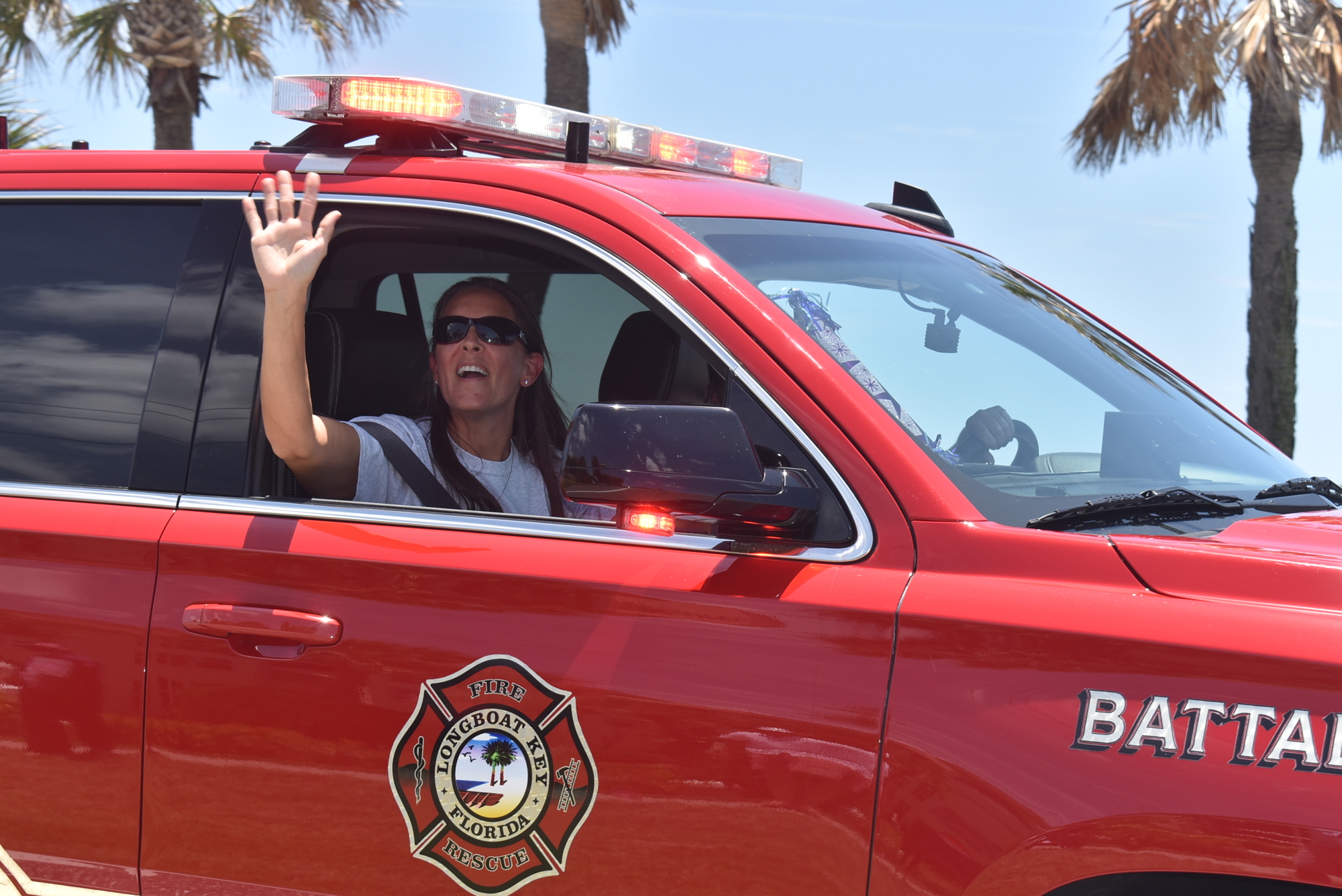 Tina Adams waves at a drive-by birthday.