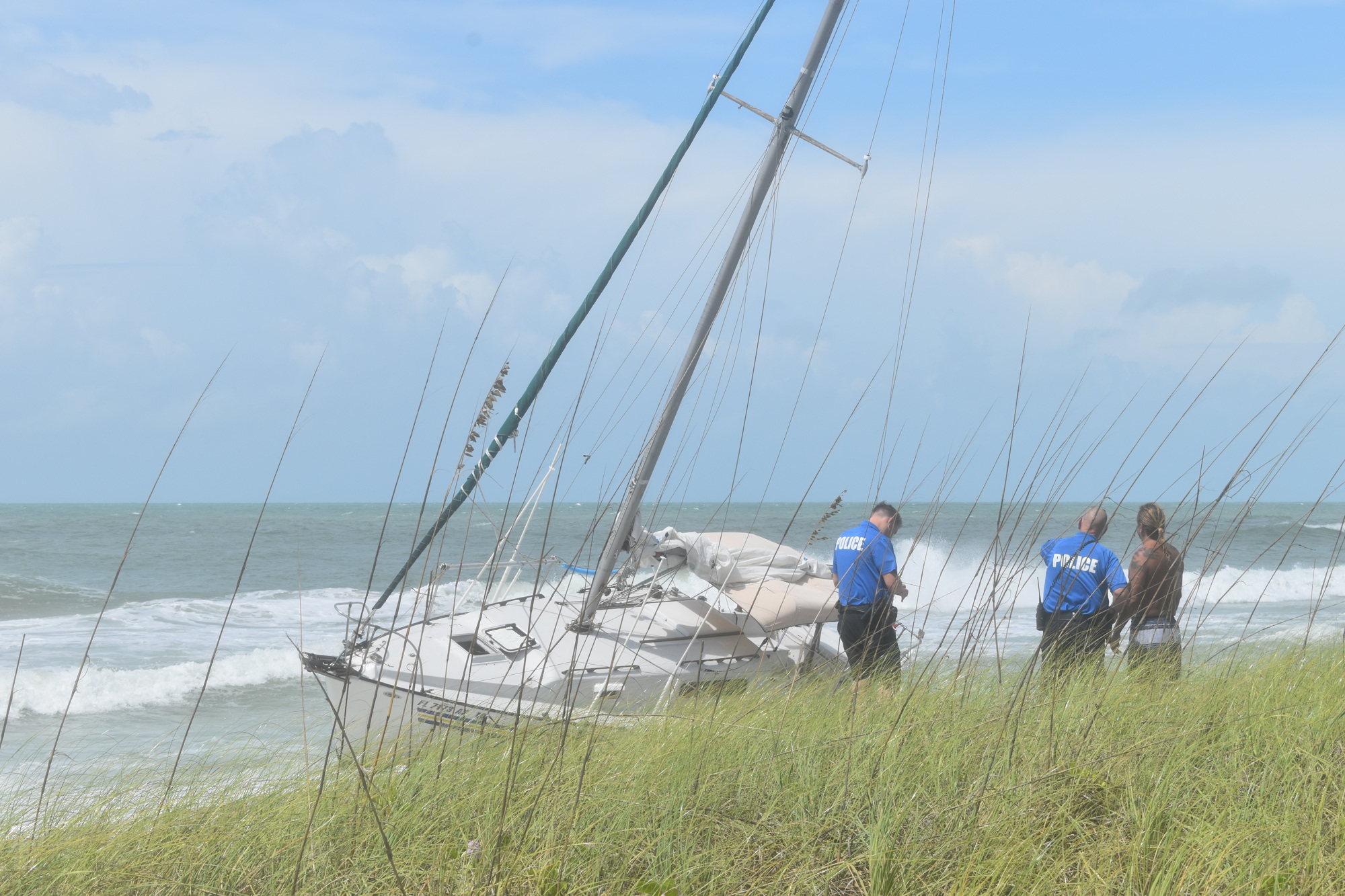 Mark Sternal speaks with Longboat Key police on Sept. 16 after his sailboat washed ashore near 4239 Gulf of Mexico Drive.