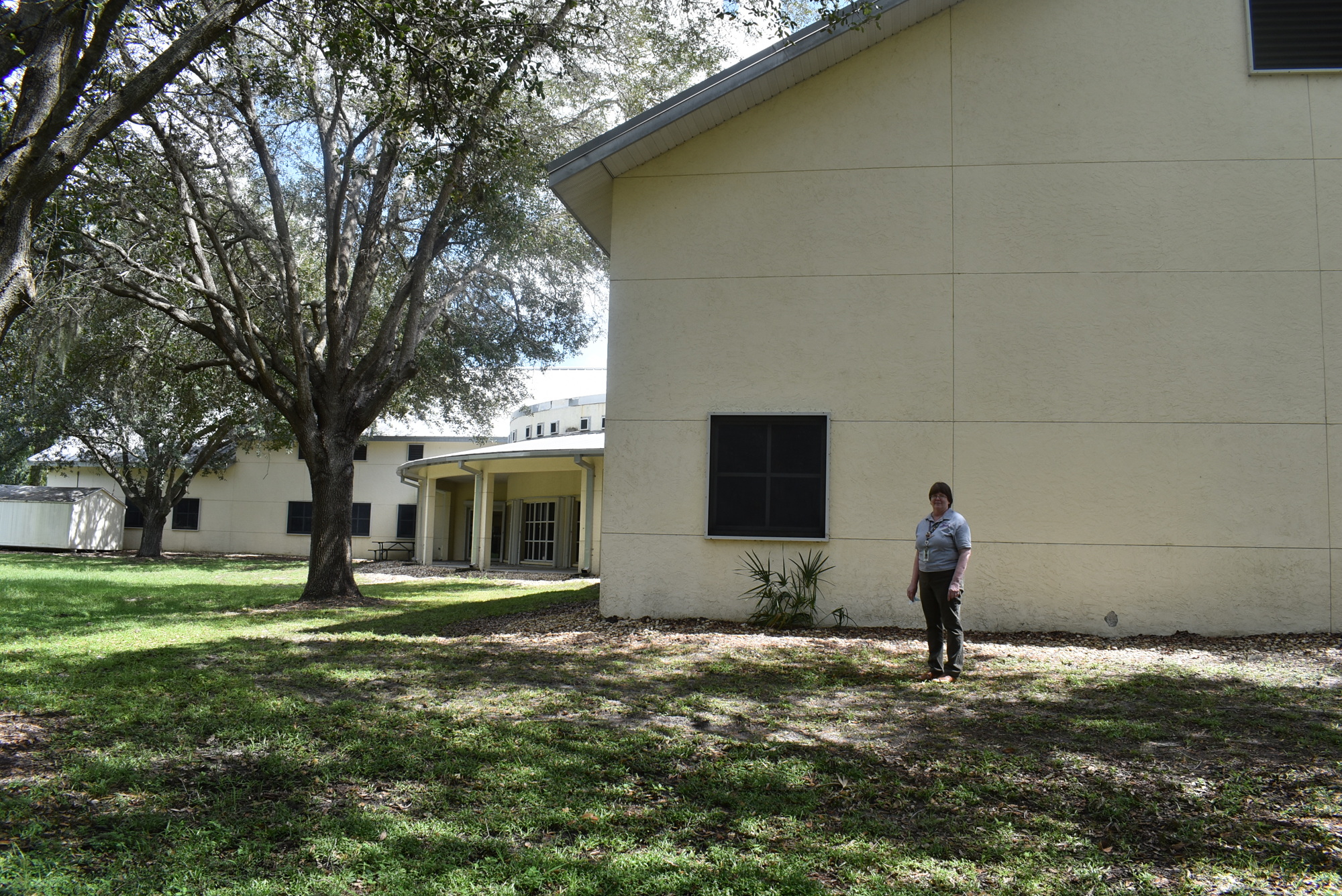 Cathy Laird, branch manager of the Braden River Library, stands on the ground where the expansion project will take place. The project is expected to be completed by Sept. 2021.
