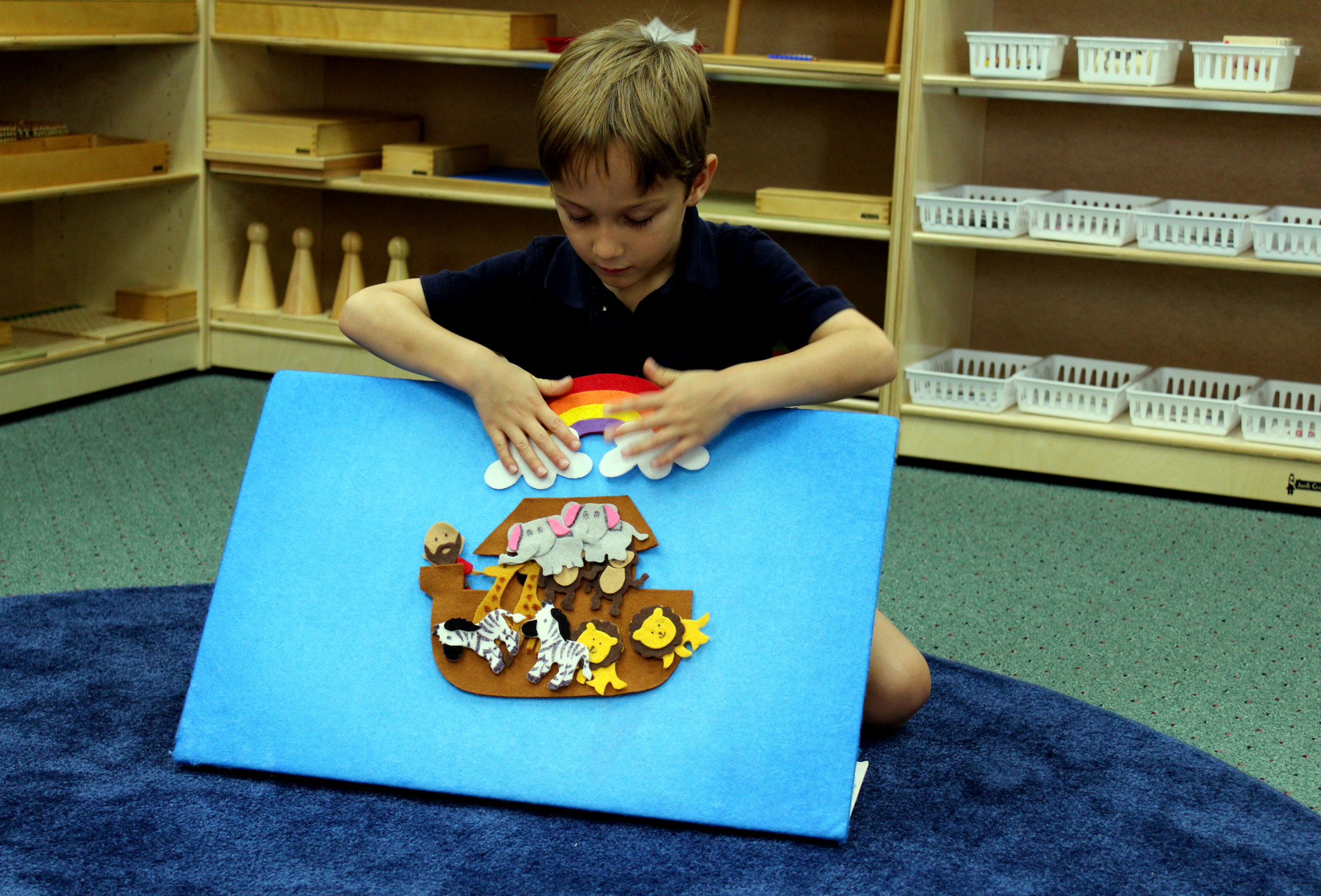 Luke Bowman, 5, uses a felt board to teach the story of Noah's Ark to his classmates. Brynn Mechem
