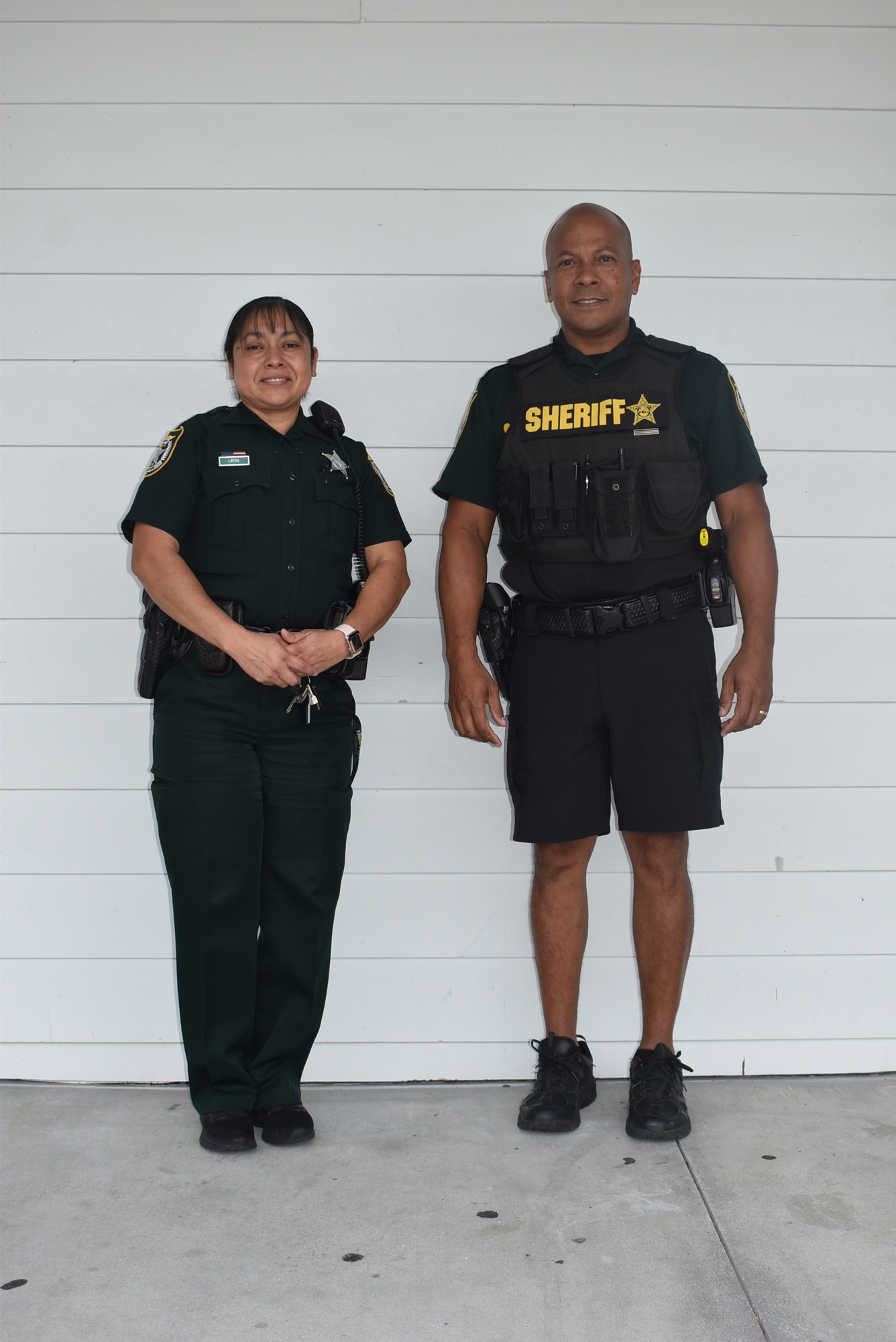 Deputy Leticia Leon (left) sports her Class B uniform, which is most often used in winter. Lt. Robert Pereyra wears the summer uniform.