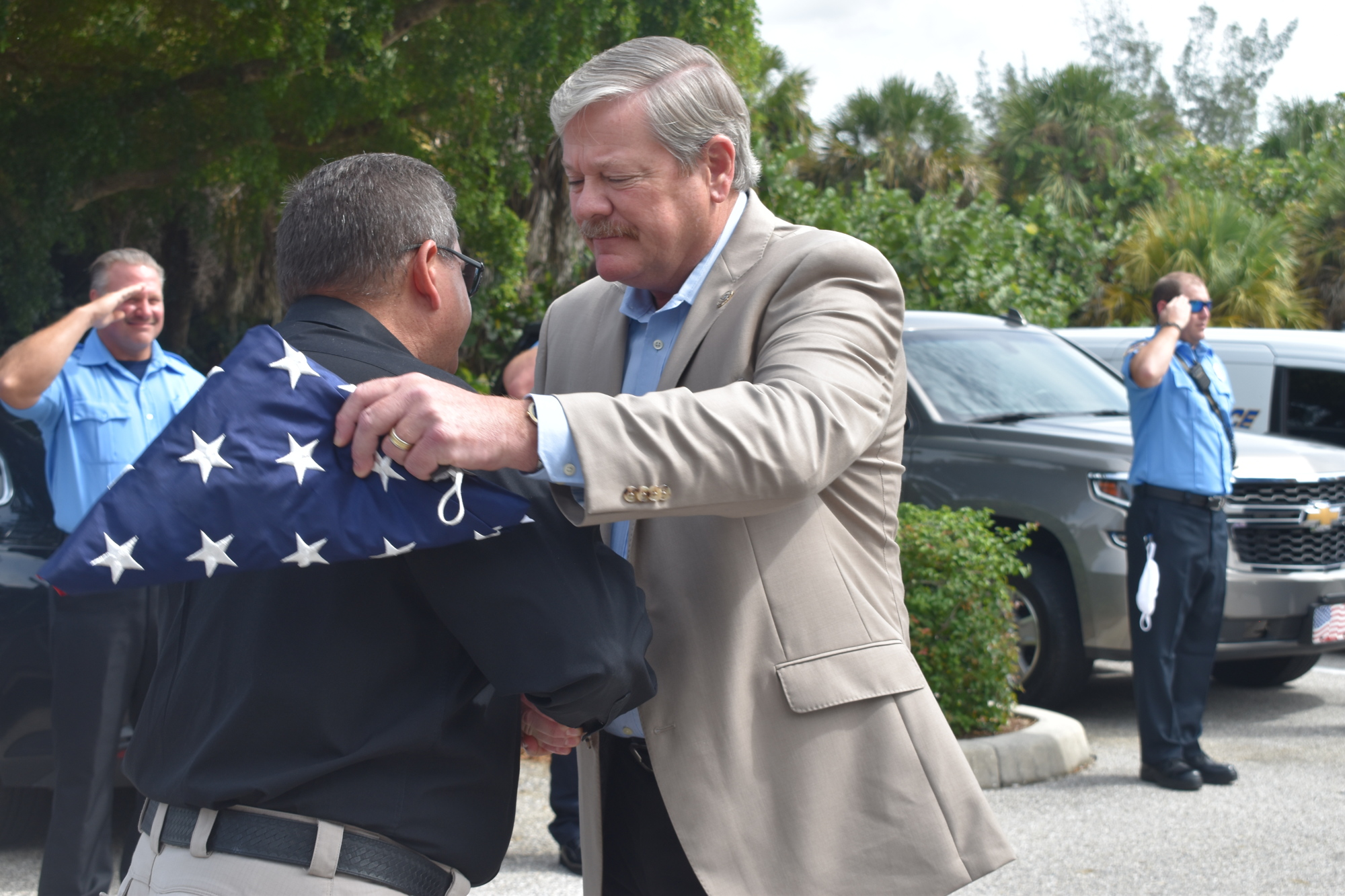 Deputy Police Chief Frank Rubino presented retiring Police Chief Pete Cumming with an American flag on Friday afternoon.