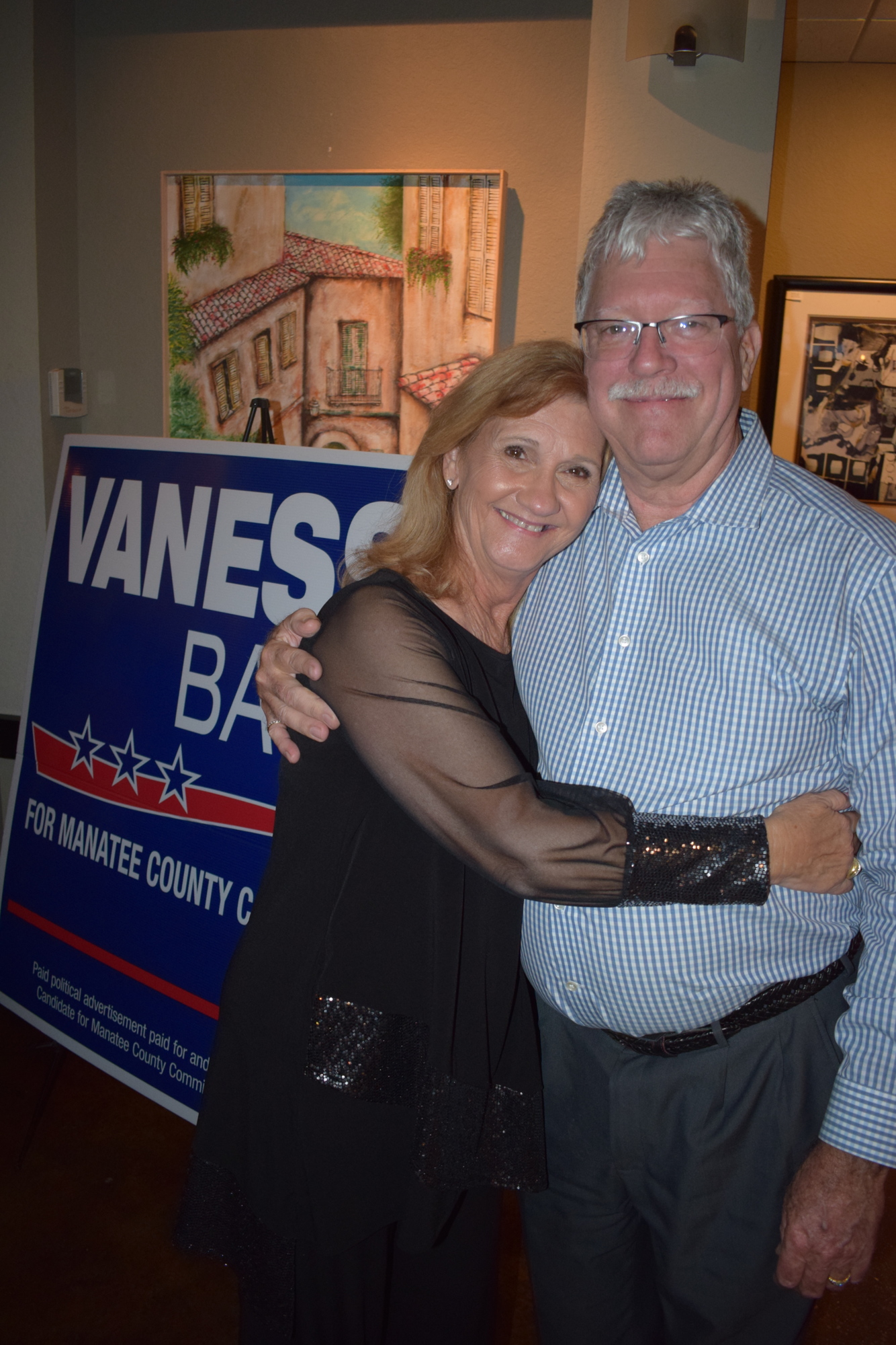 Vanessa Baugh celebrates another four-year term as District 5 commissioner with her husband Don during a victory party at Main Street Trattoria in Lakewood Ranch.