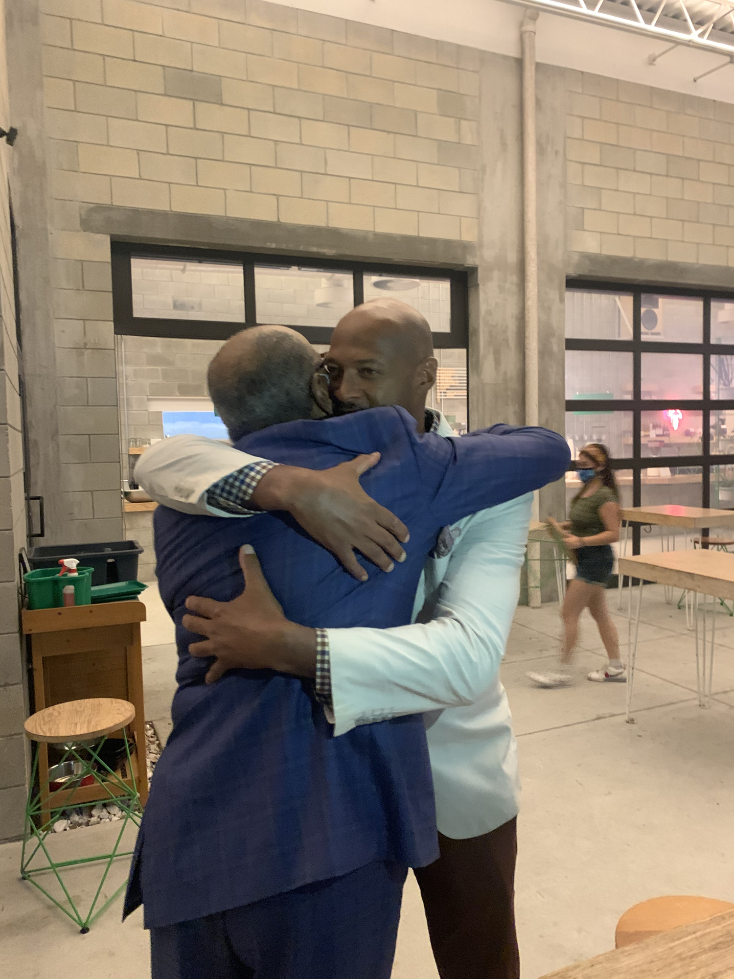 Kyle Scott Battie, right, hugs his father, Hank Battie after hearing the results of Tuesday’s District 1 City Commission election. Photo courtesy Hagen Brody. 