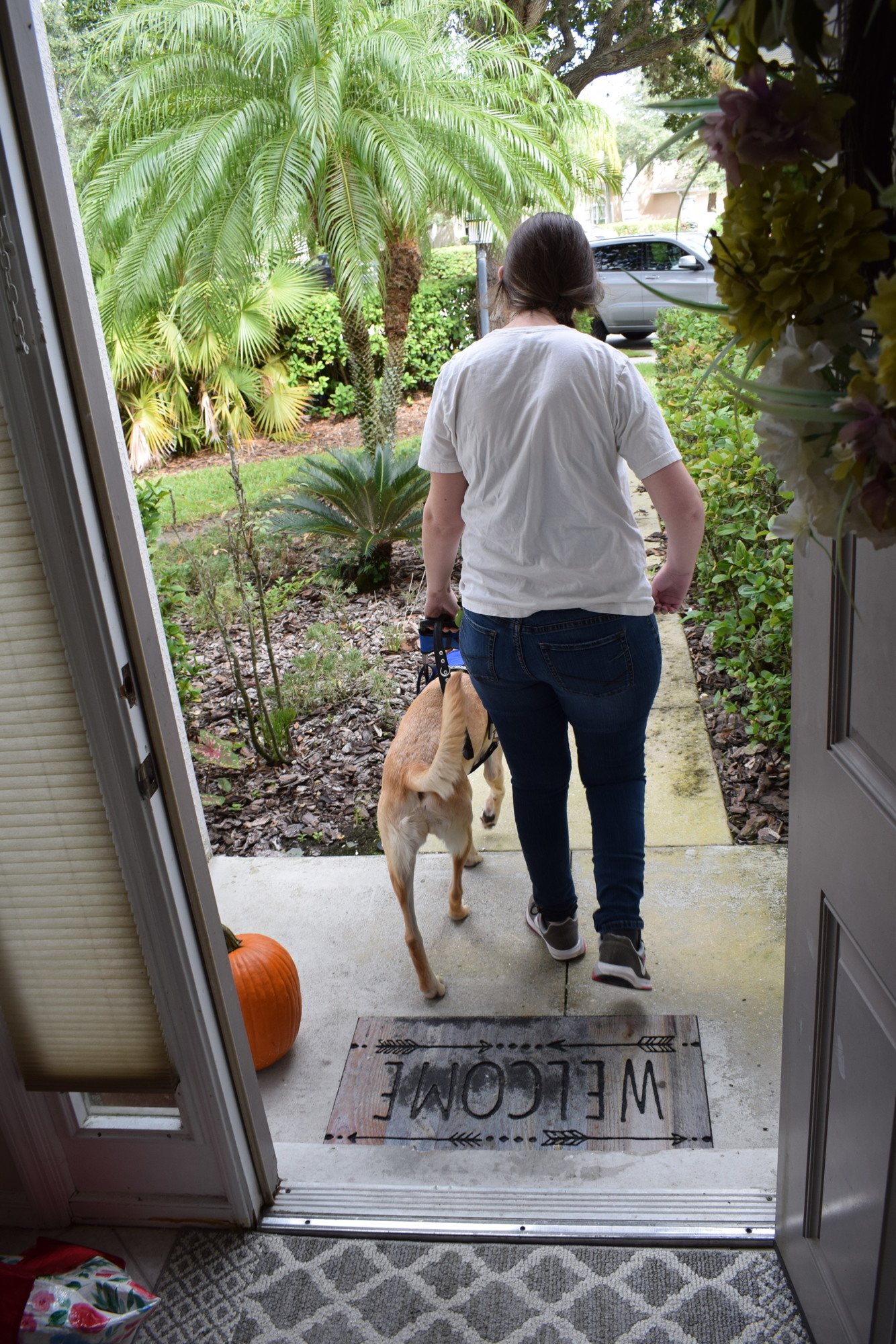 Greenbrook's McKenzie Hanlon heads out the door with her new guide dog, C.J.