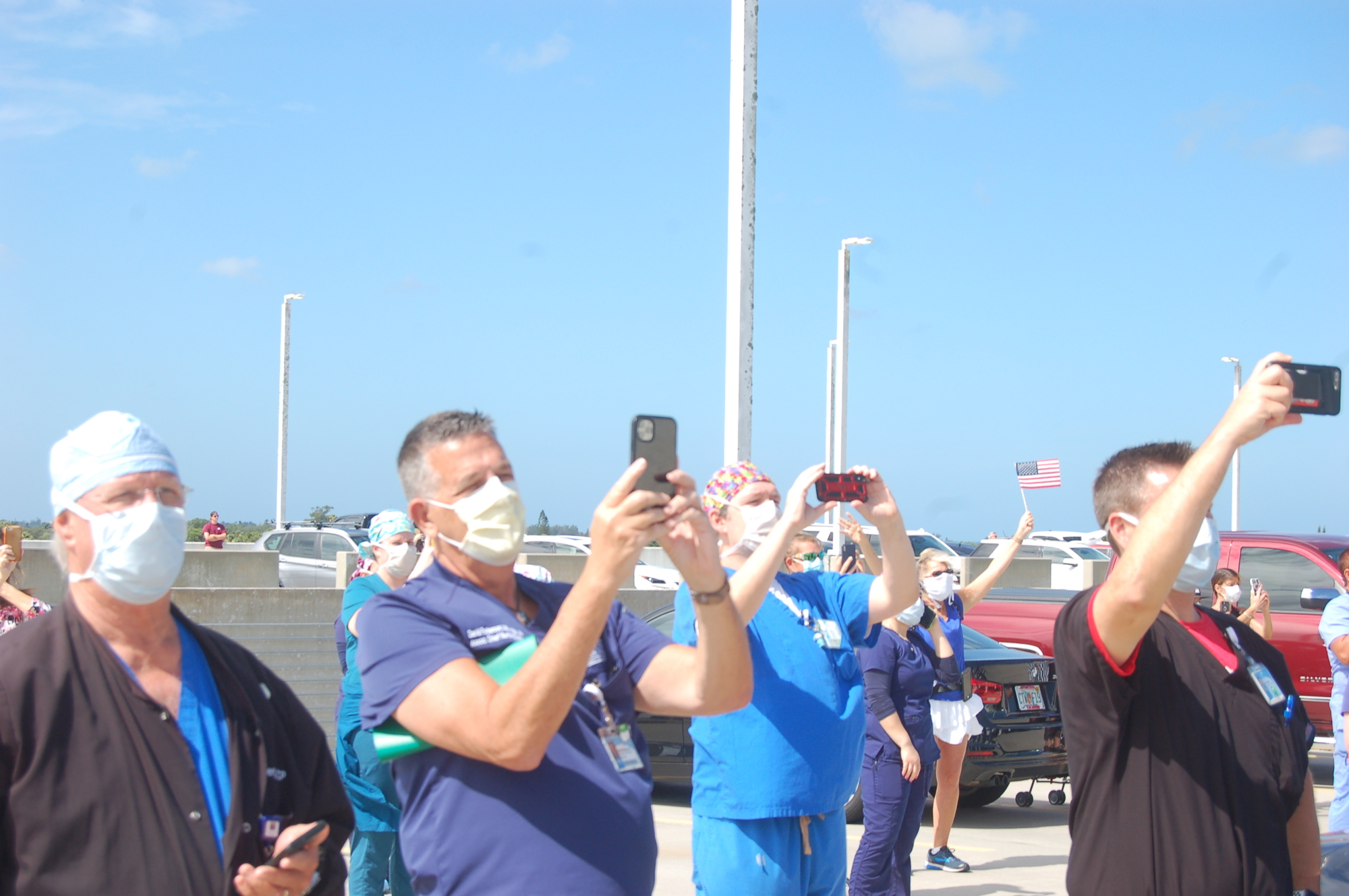 Sarasota Memorial Hospital staff, all masked up, watched an Air Force flyover from the roof. 