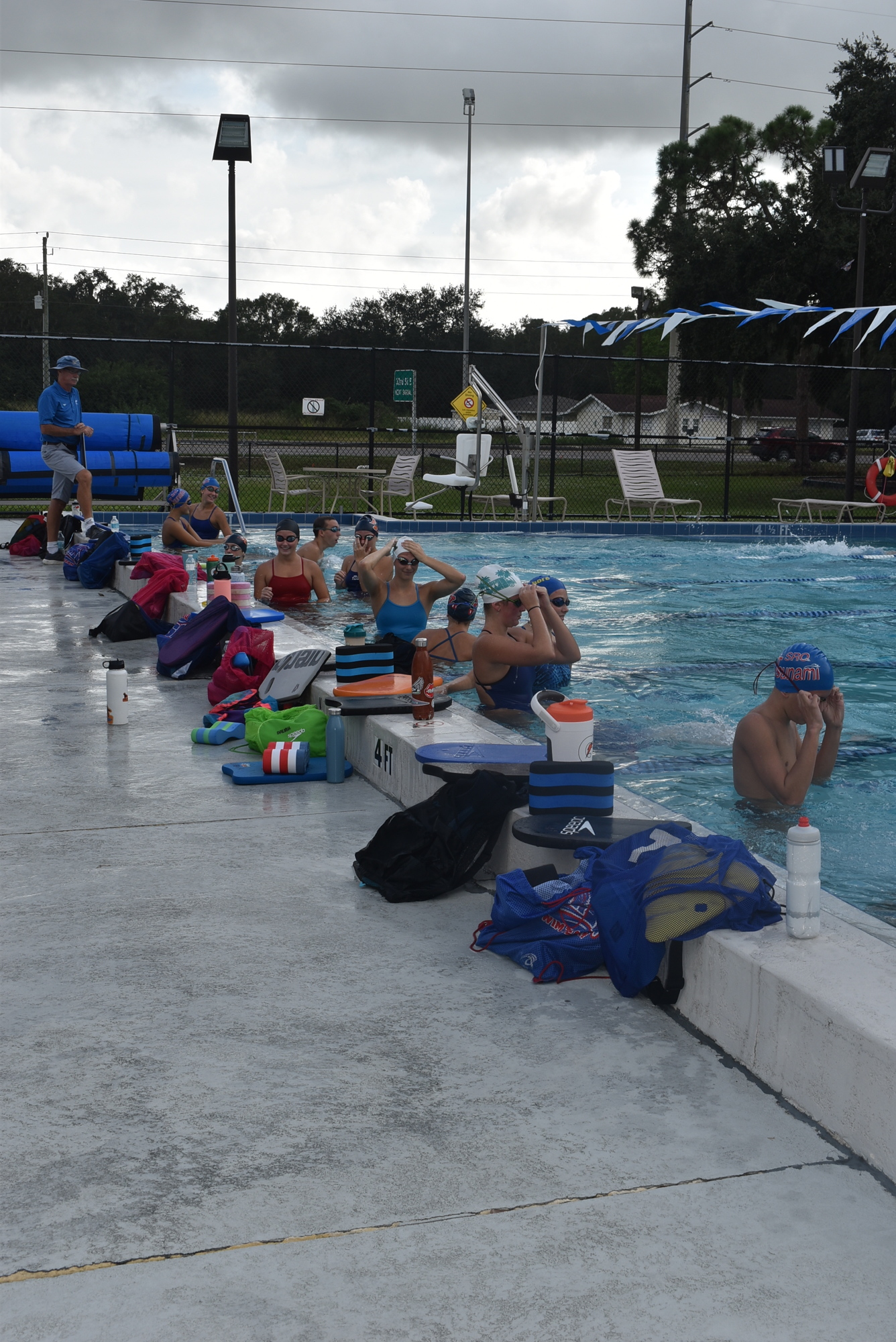 Tsunami coach Guy Bergeron instructs his swimmers during a Thursday practice. The Tsunami used to practice at Marble Pool every weekday afternoon, but are now limited to Tuesday and Thursday afternoons.