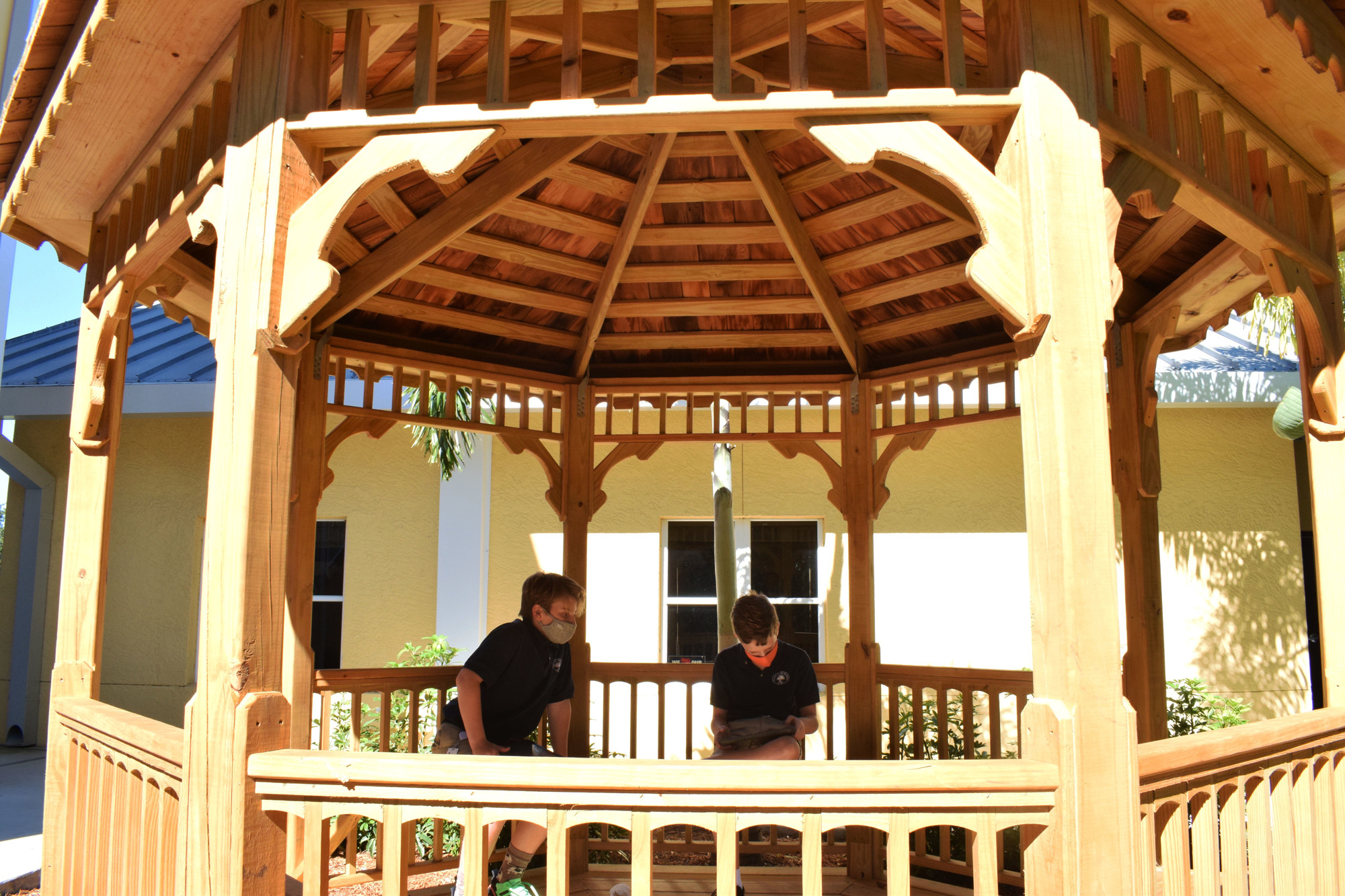 Sixth graders Wilkes Borden and Nathan Crews work on a health assignment in the gazebo on campus.