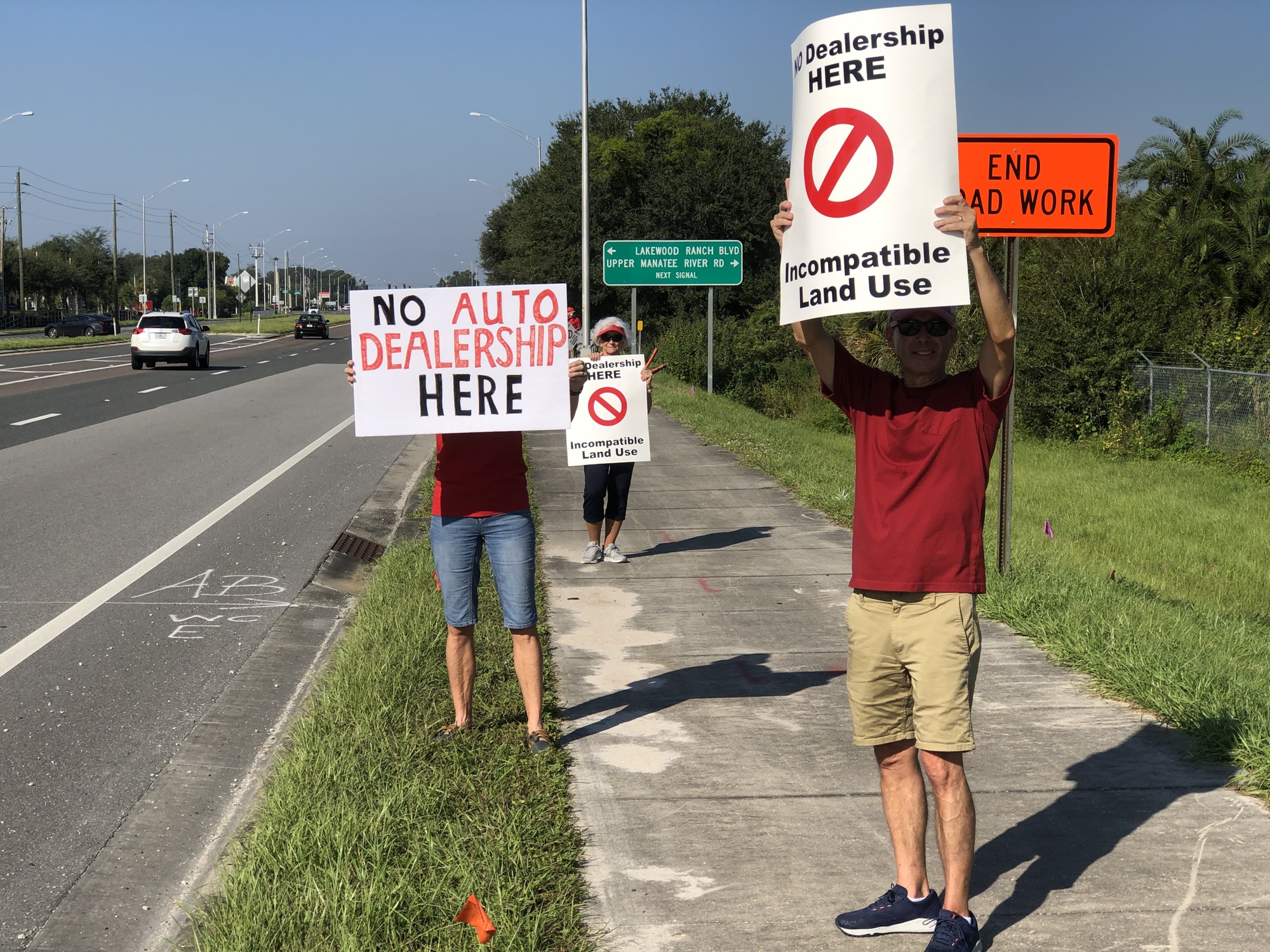 Opposed residents who live near the site of the proposed dealership protest in front of the site Oct. 17 on State Road 64. Some residents have formed a nonprofit and filed an appeal against Manatee County.
