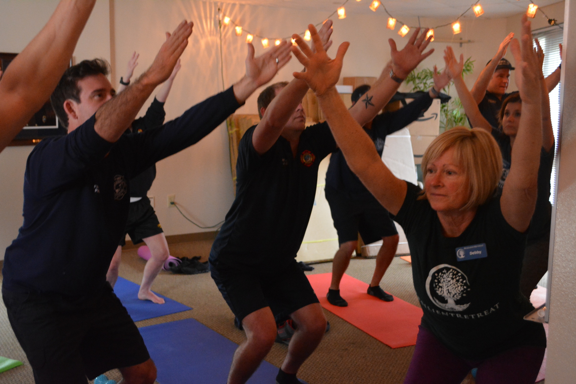 Feb. 20: Firefighters and yoga instructor Debby McClung work their way through some stretches.