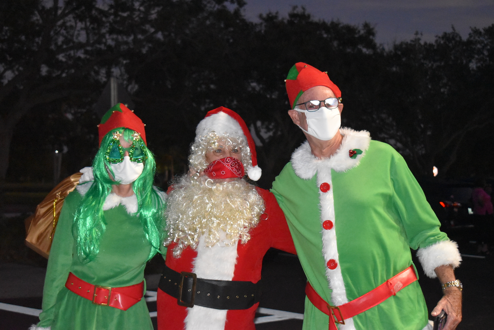 Dec. 10: Nancy Rozance as Santa is flanked by elves Henriette Van Eck and Martin Poretsky.