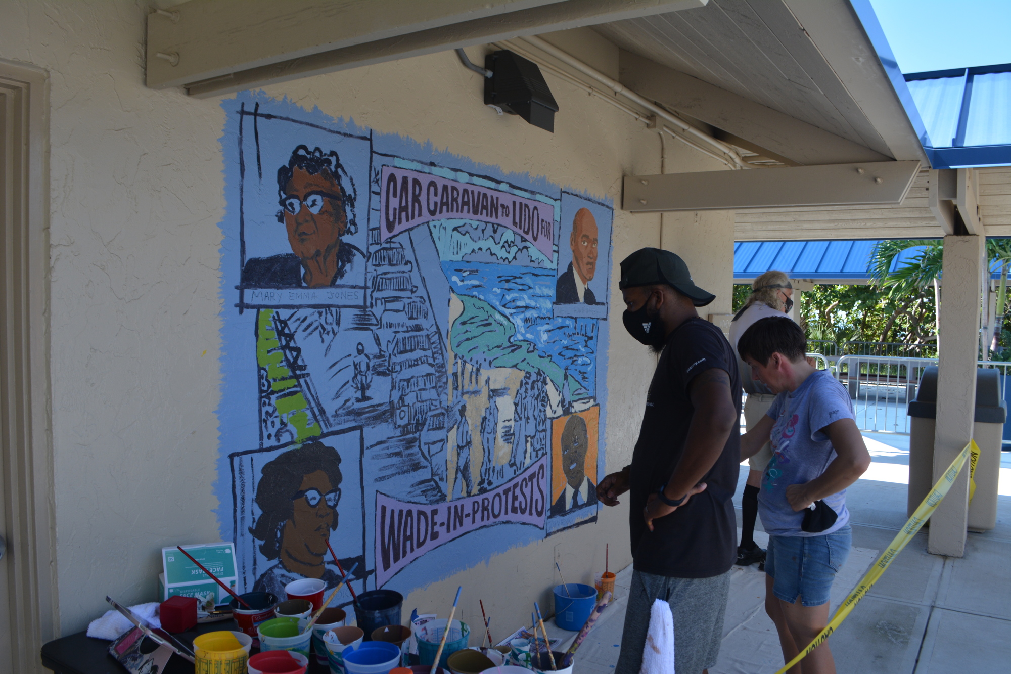 Sept. 24: Artists Paul Lee and Julie Kanapaux work on a mural at Lido Pavilion.