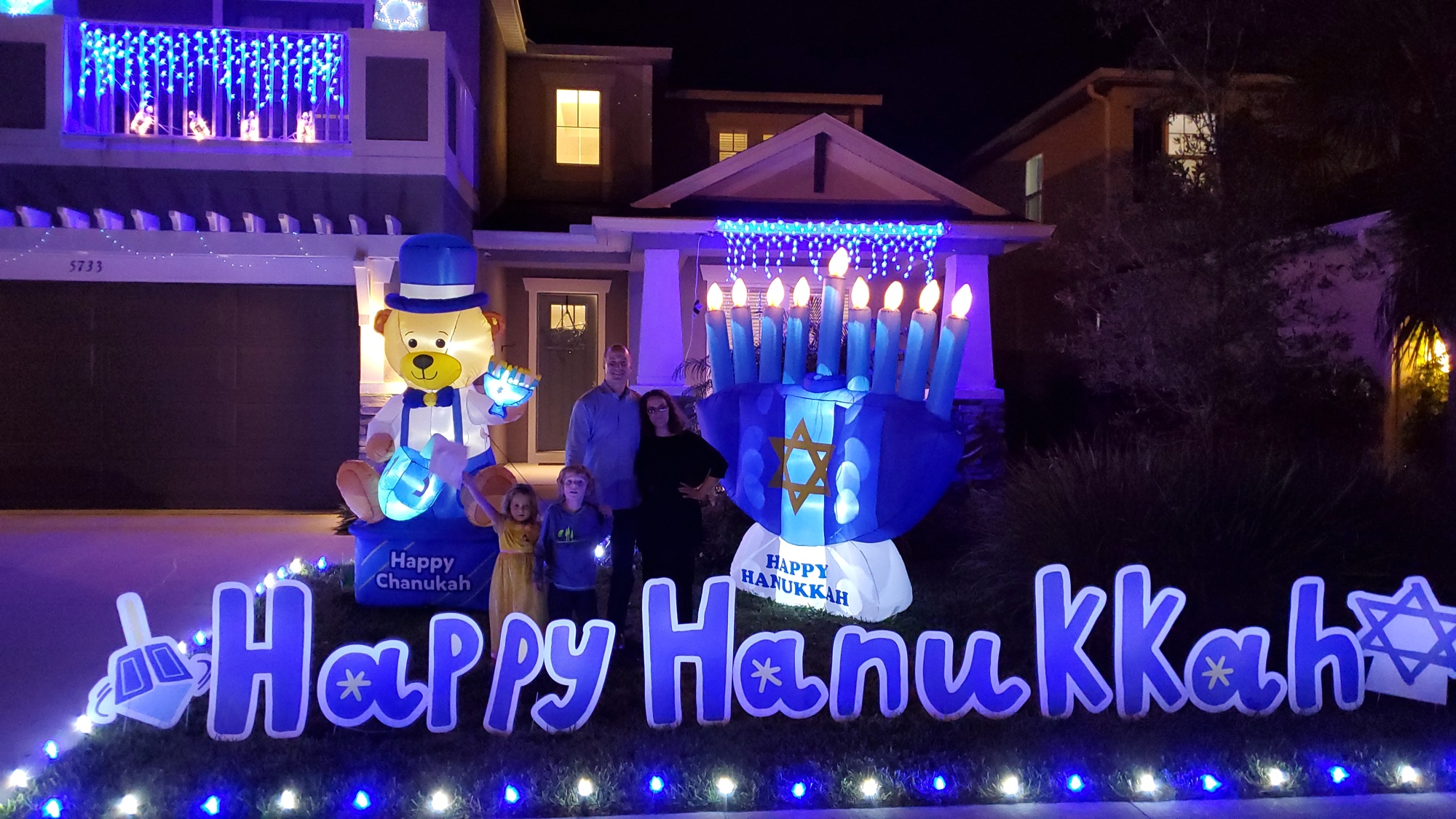 Rabbi Samantha Kahn and her family are celebrating the Festival of Lights with bright yard decorations.
