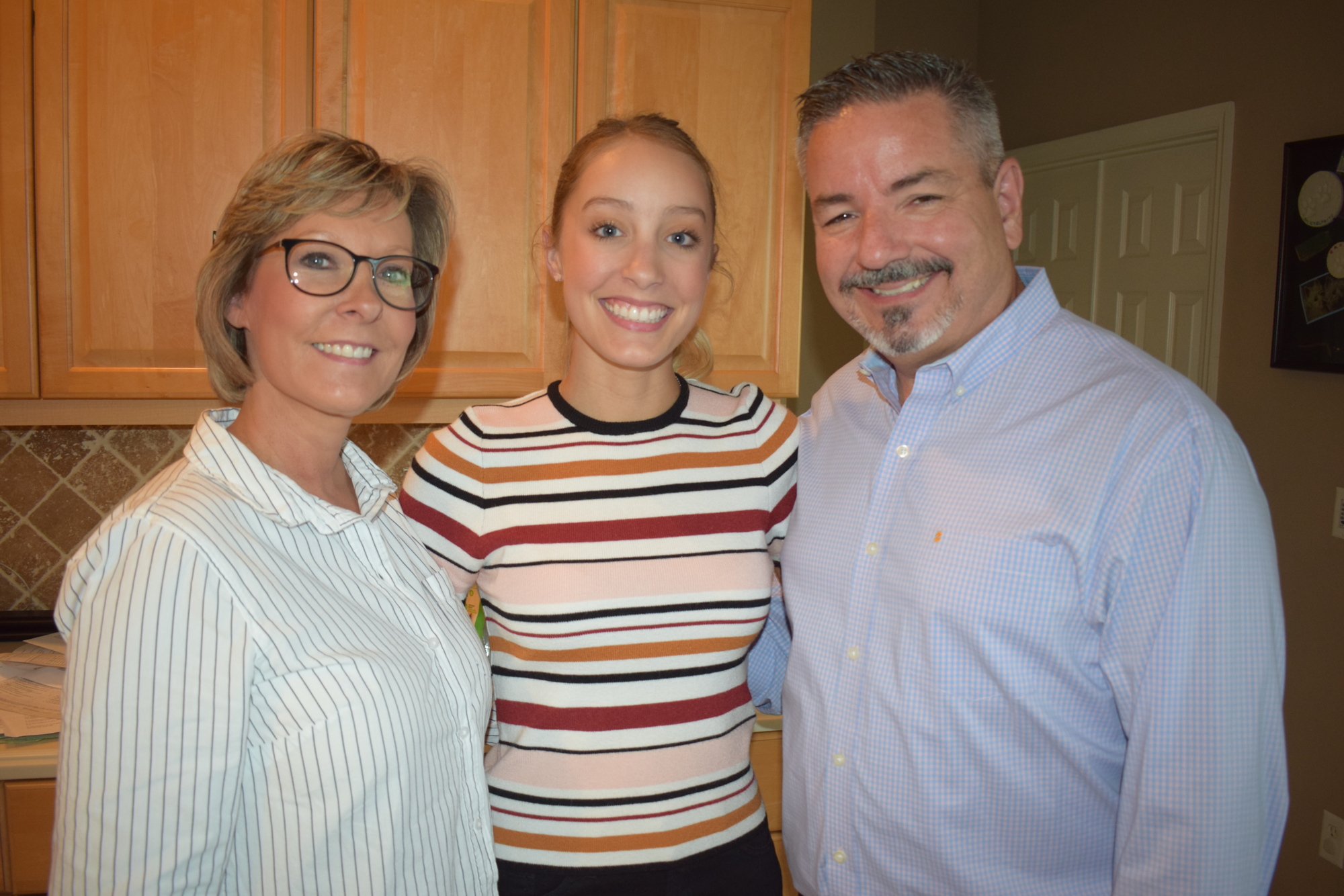 Tina, Madison and Mark Abbacchi celebrate Madison's amazing string of As all through her academic career.