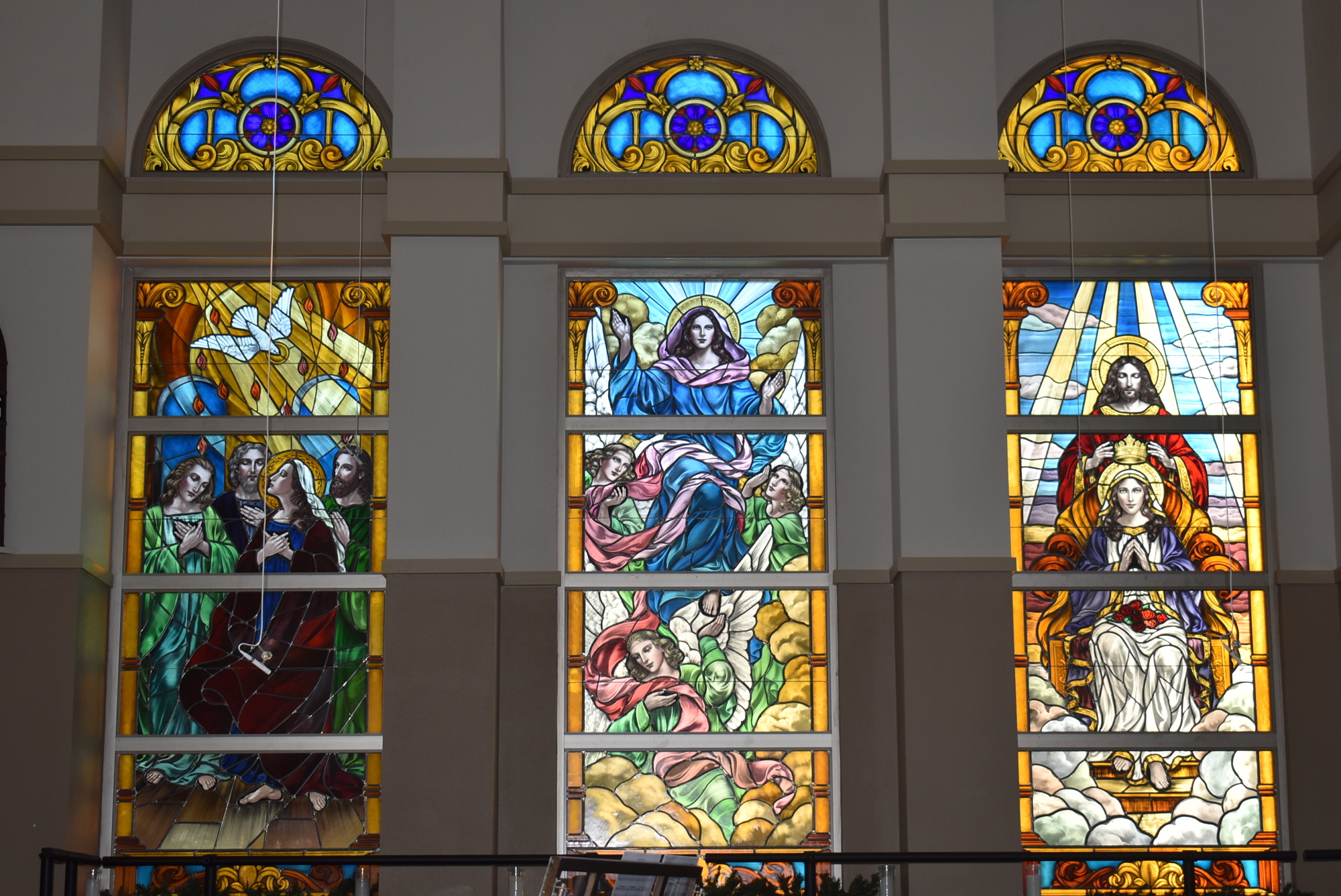 These stained glass windows, installed at Our Lady of the Angels in 2020, depict the descent of the Holy Spirit onto the Apostles (also known as Pentecost), assumption of Mary into Heaven and coronation of Mary in Heaven.