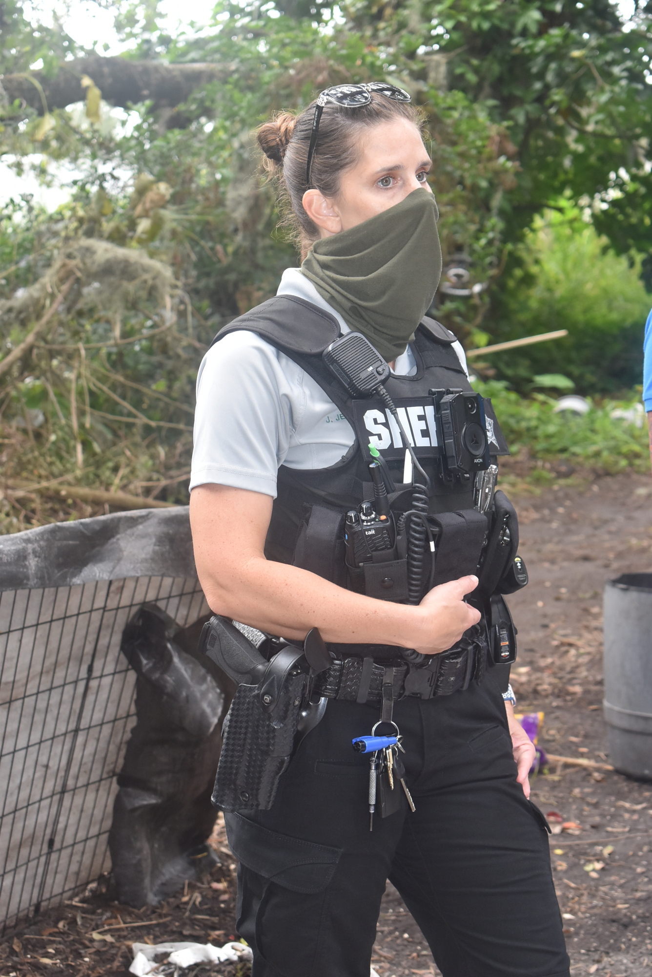 Manatee County deputy Joy Jewett walks through a homeless camp Dec. 14 in Bradenton. Jewett gives her phone number to anyone who will accept it, encouraging them to call her day or night.