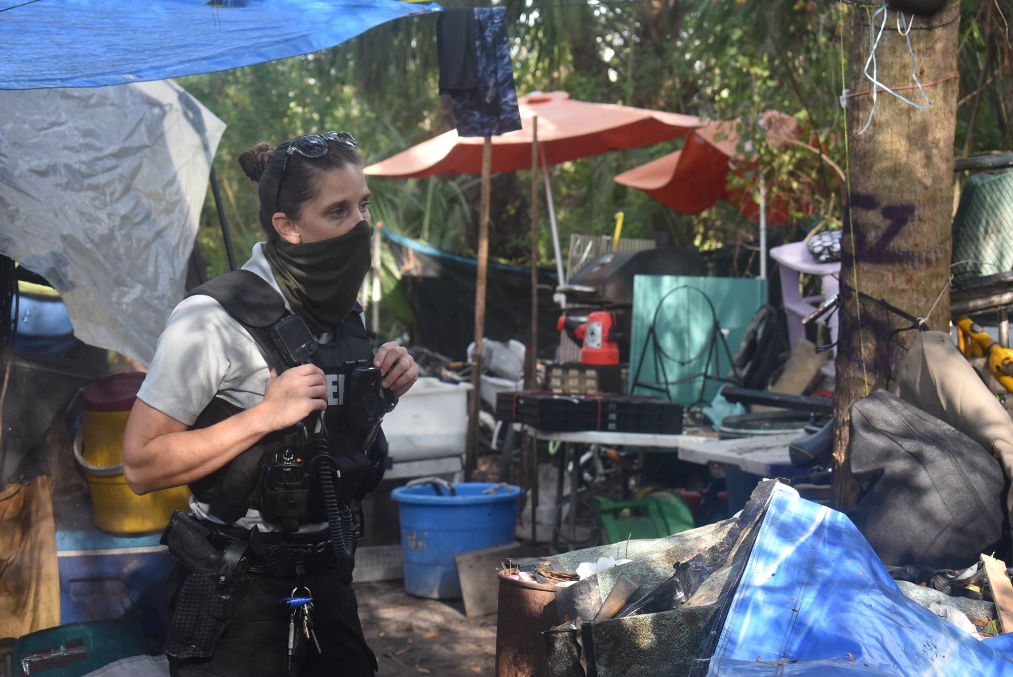 Manatee County deputy Joy Jewett walks through a homeless camp Dec. 14 in Bradenton. Jewett gives her phone number to anyone who will accept it, encouraging them to call her day or night.