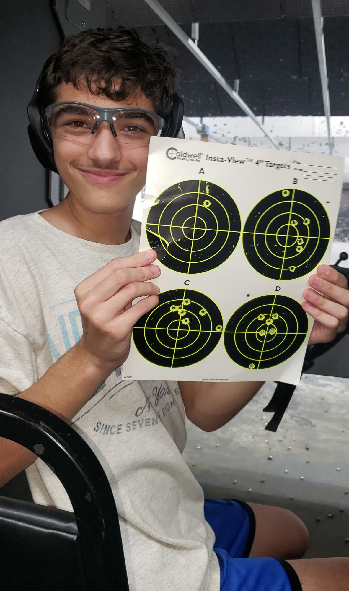 Dominic Caporaso, a member of Boy Scout Troop 191, shows off his targets during a rifle merit badge workshop. Courtesy photo.