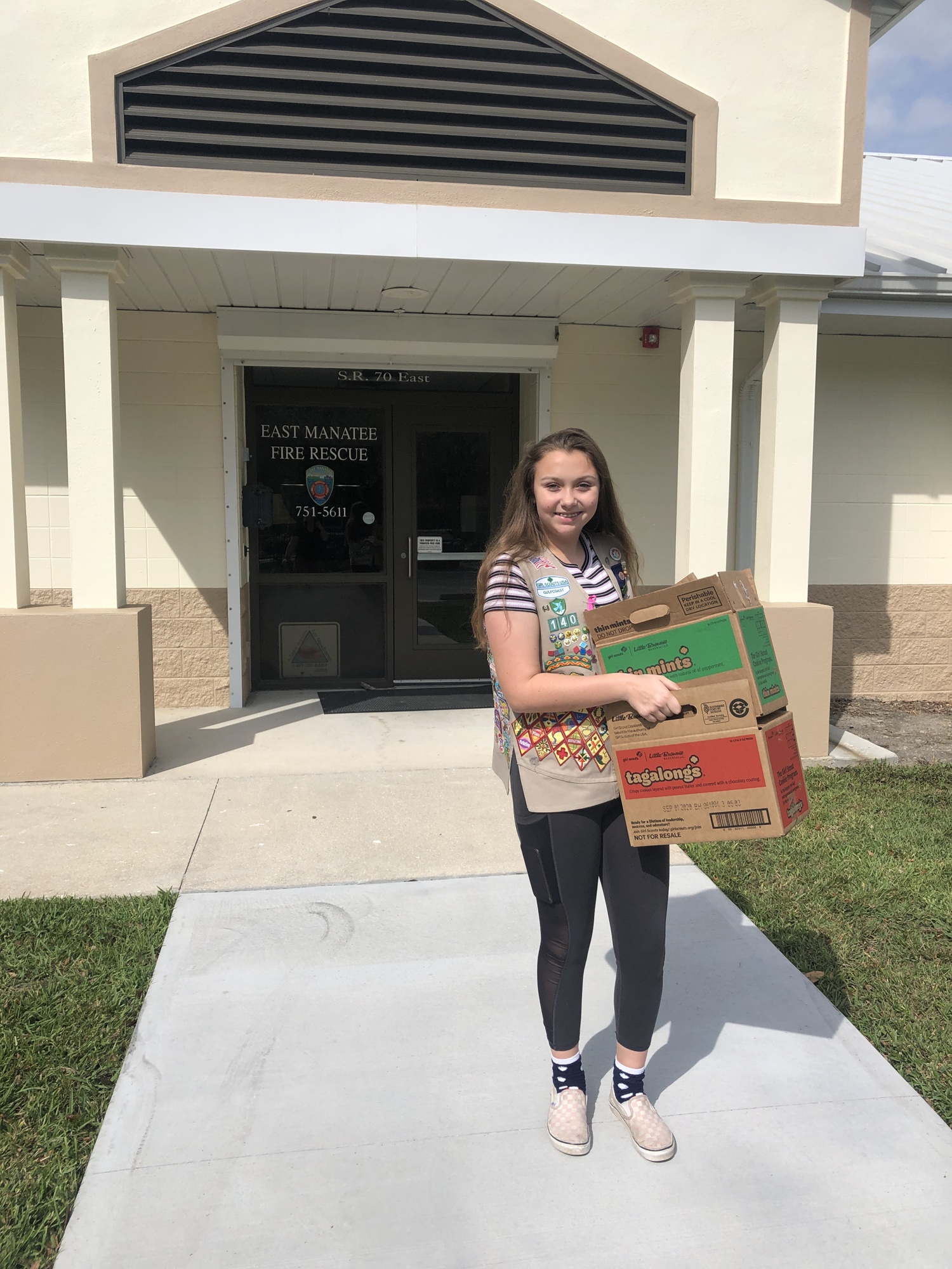 Victoria Moore, a member of Girl Scout Troop 140, delivers cookies to East Manatee Fire Rescue. Cookie season is starting again, and girls will have to come up with new ways to sell cookies due to the pandemic. Courtesy photo.