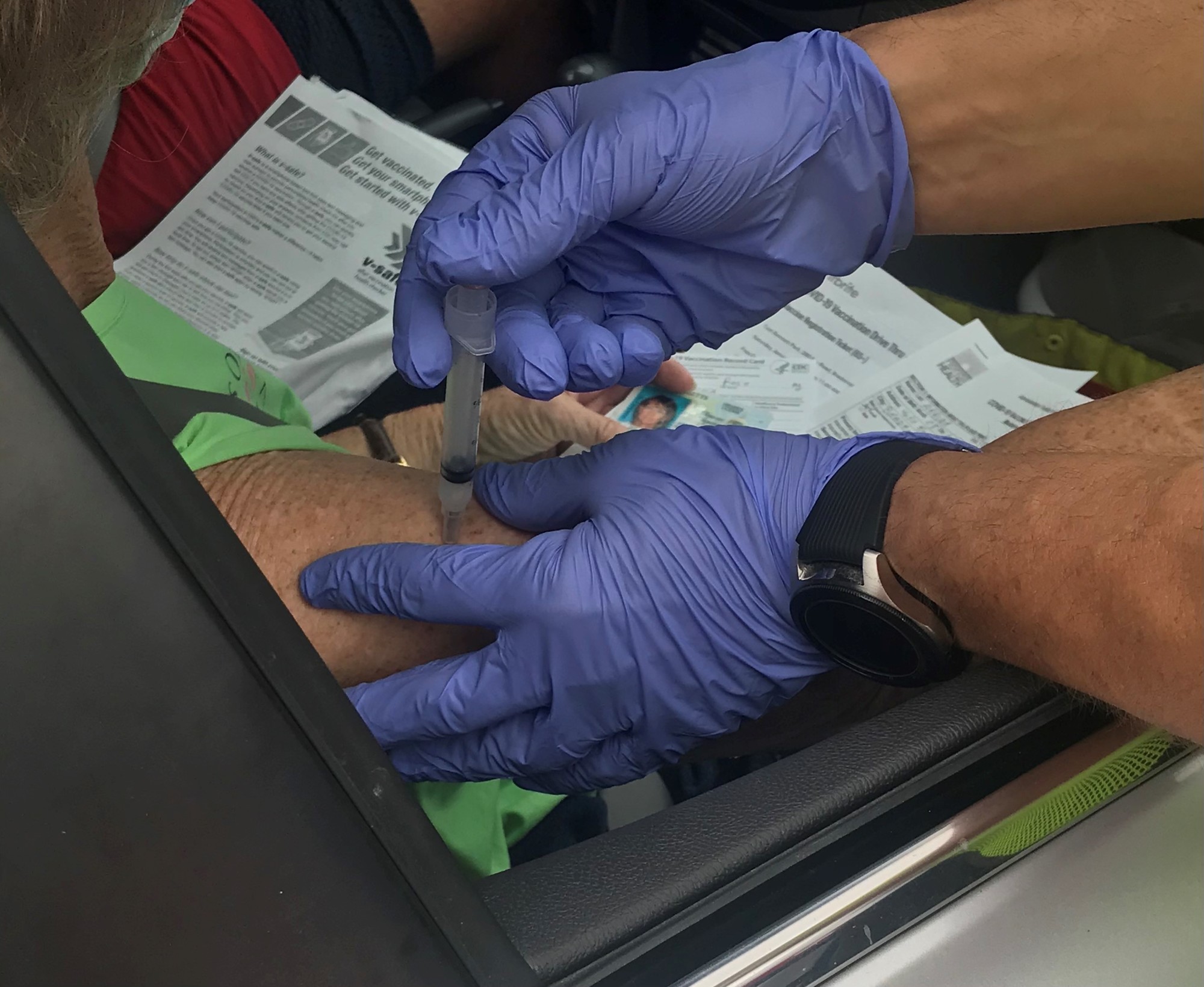 A COVID-19 vaccination is given to a visitor to the drive-thru vaccination operation at Tom Bennett Park. (Courtesy Dept. of Health)