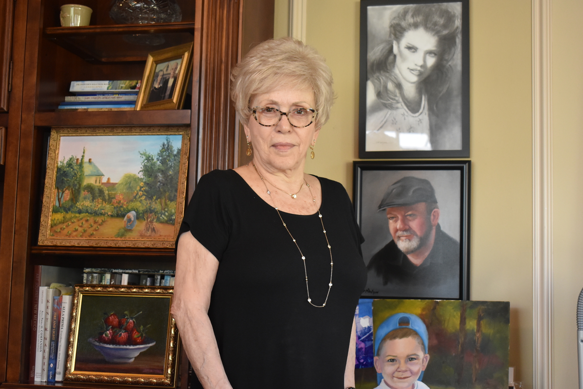 Country Club resident Donna McIntyre, 79, stands among her paintings in her art studio two days after receiving her first dose of the COVID-19 vaccine. She is looking forward to painting with her friends again.