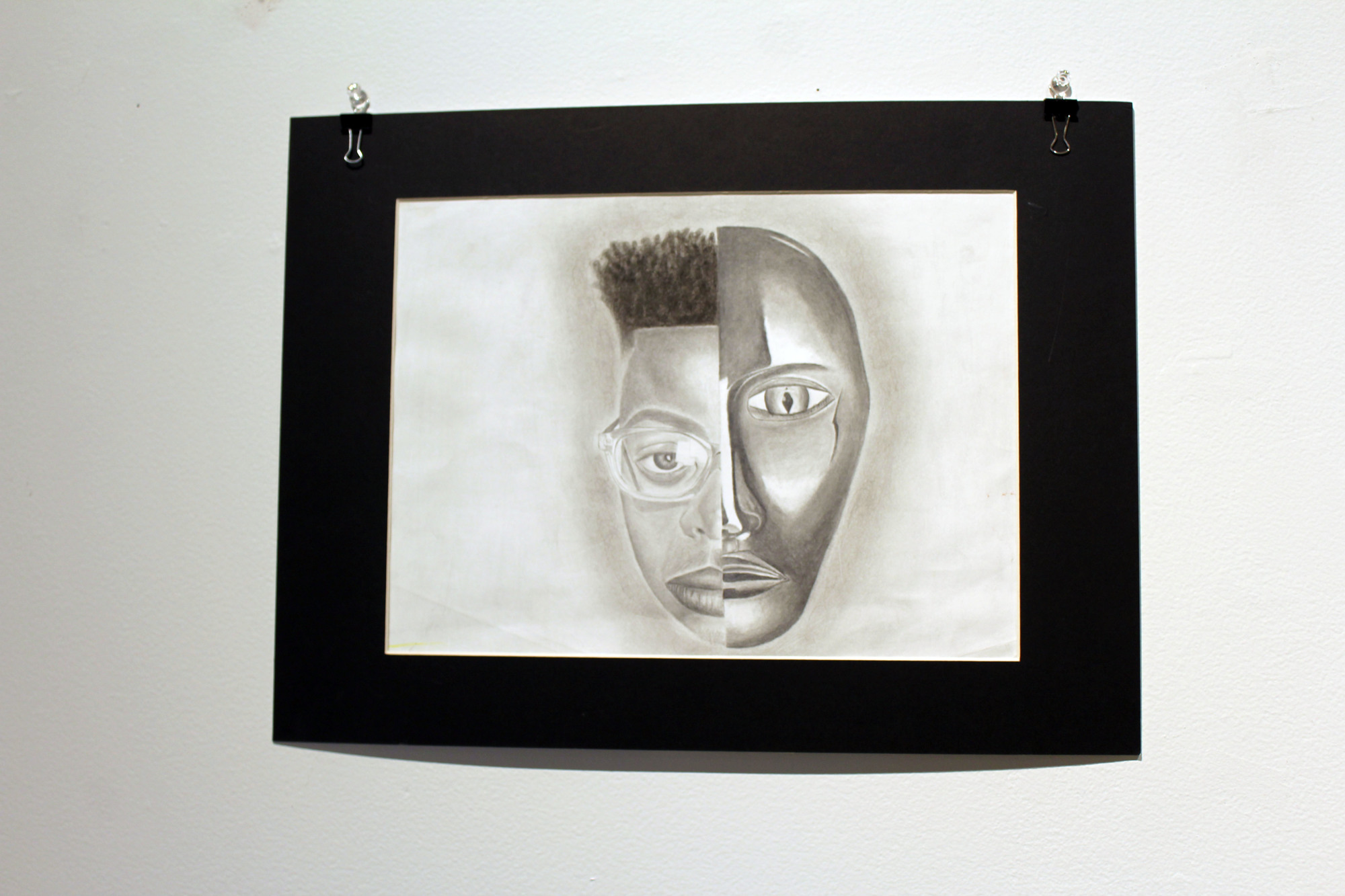 North Port High student Marcus Drummond portrays a two-faced man to depict how he hides his true emotions with smiles, as if he's wearing a mask.