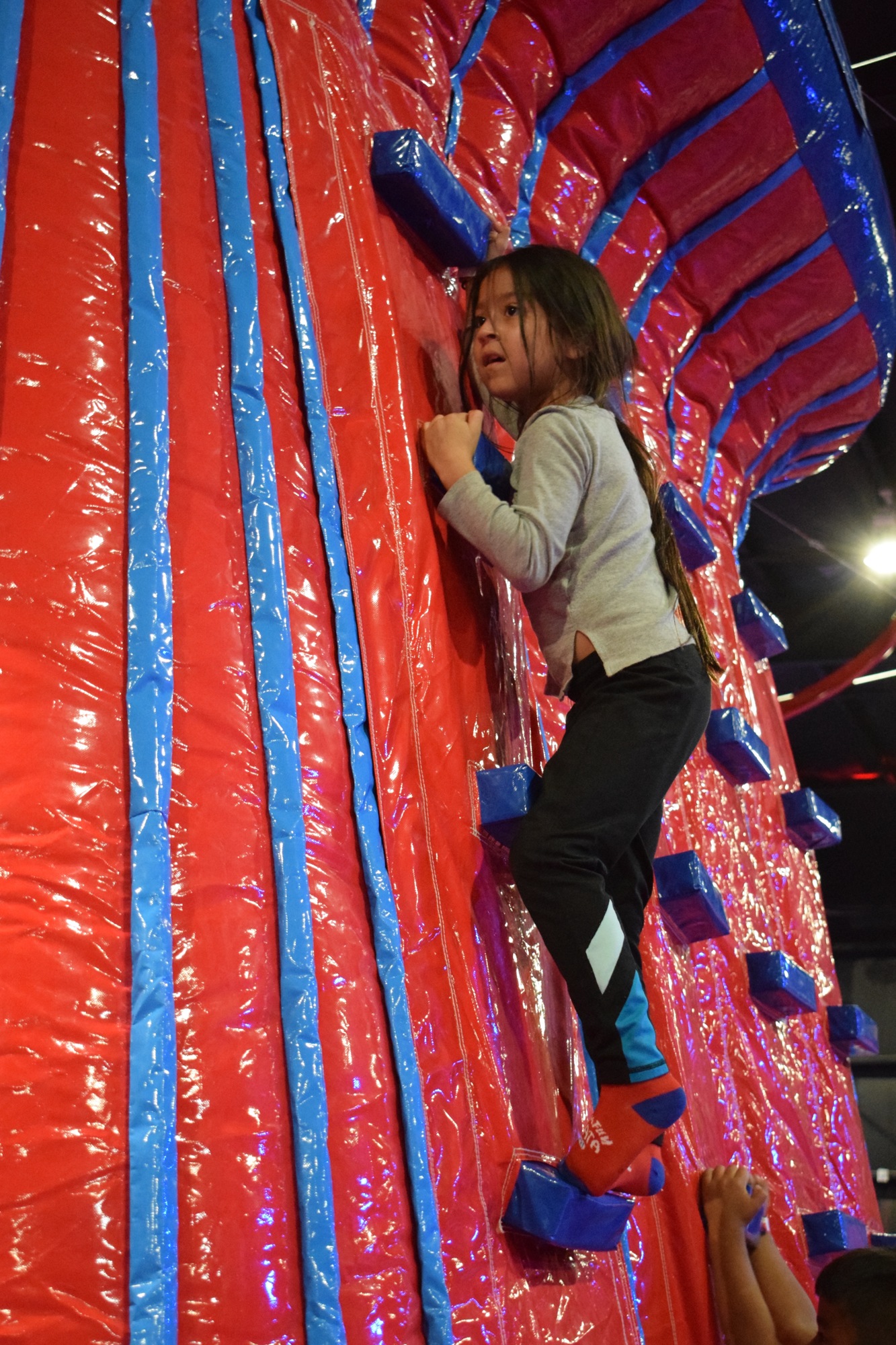 Freedom Elementary School third grader Grecia Montemayor climbs an inflatable wall during a PTO event at Jumpin Fun Inflata Park.