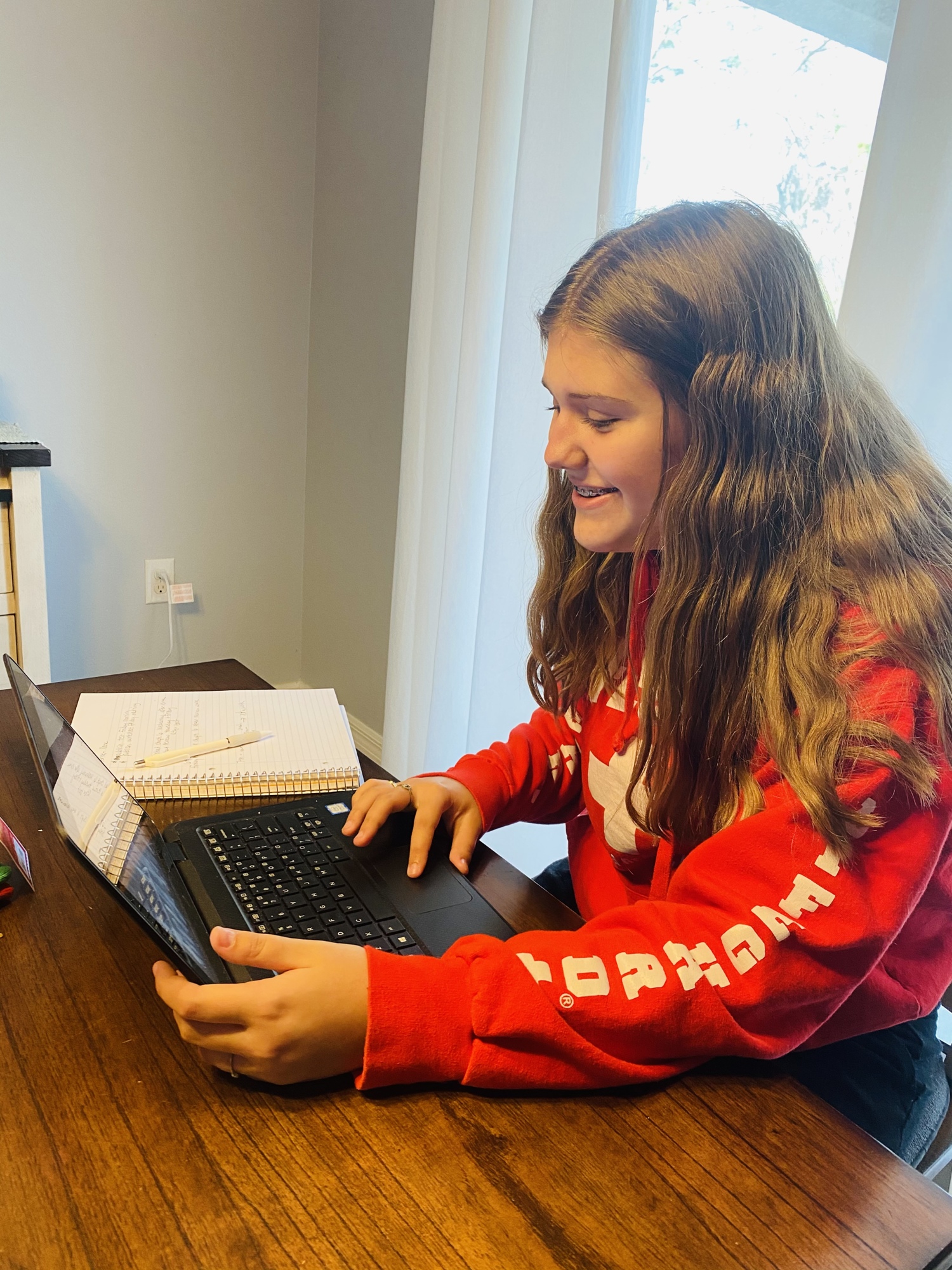 Delainey Puelston, an eighth grader at Carlos E. Haile Middle School, works on an assignment at home while quarantining. The AVID program has provided her a support group when she's had to move to e-learning.