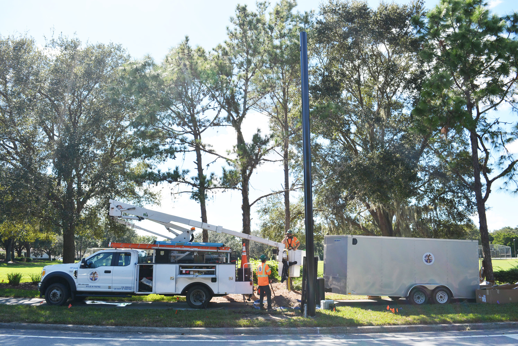 A crew from HP Communications works on a small cell pole installation in front of Summerfield Park along Lakewood Ranch Boulevard. Small cell sites have a coverage radius up to 2,000 feet. File photo.