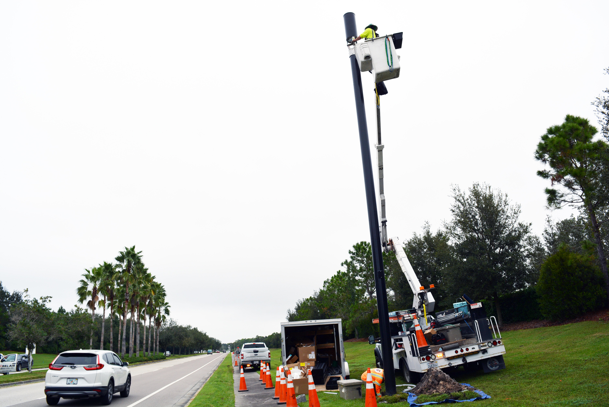 A crew from HP Communications works on installing a small cell pole  along Lakewood Ranch Boulevard at Players Drive. Small cell sites have a coverage radius up to 2,000 feet. File photo.