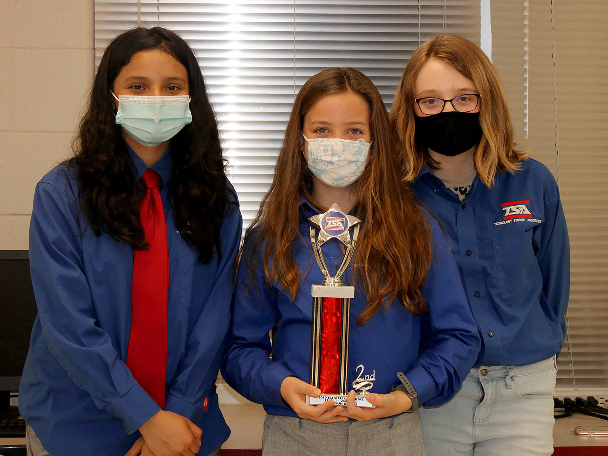 R. Dan Nolan Middle School TSA members Jasmine Tinoco, Cate Kitcher and Caroline Frisbie take pride in their second place win for Inventions and Innovations. Courtesy of Nadine Anderson.