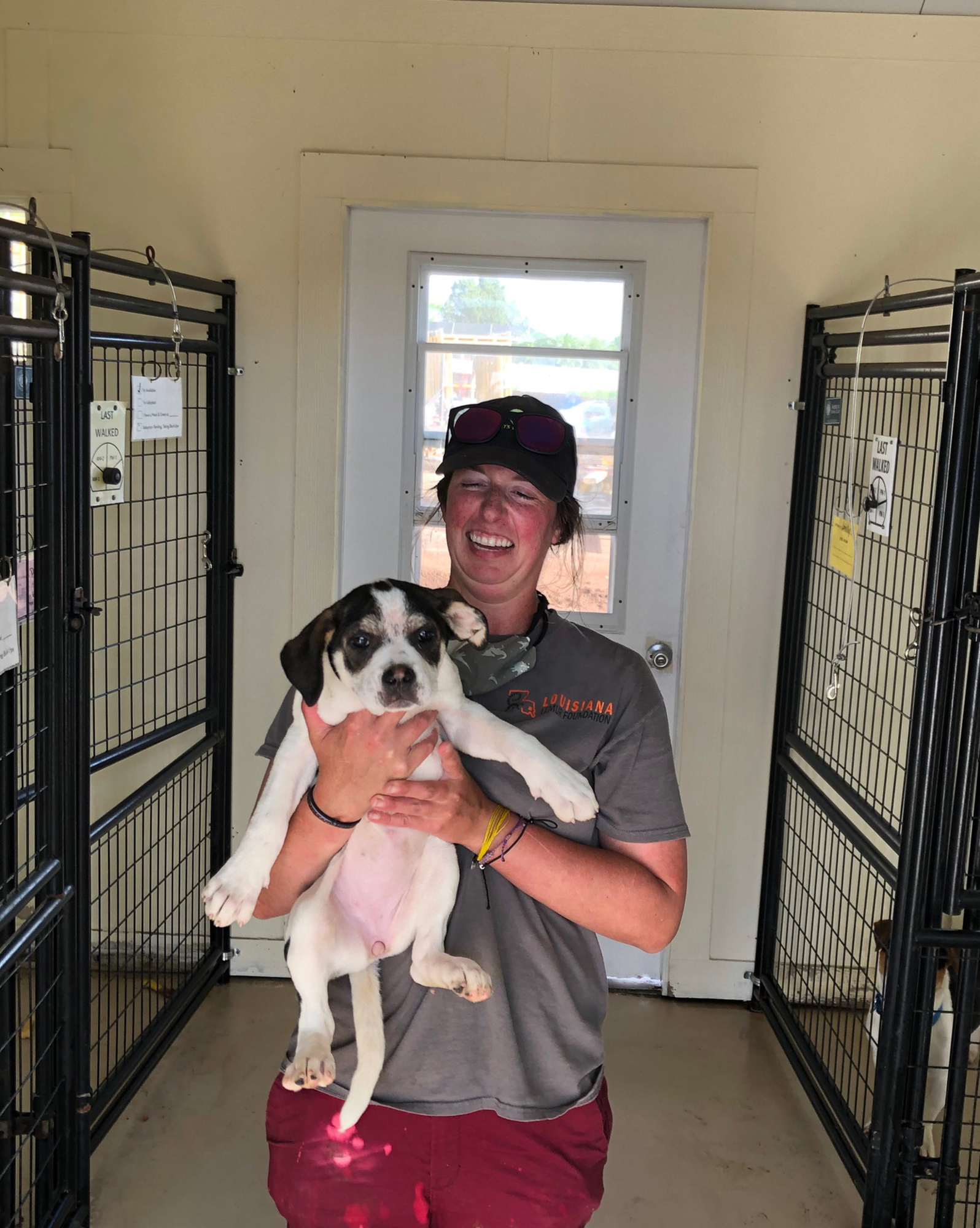 Kelsey Deenen, a staff member at Nate's Honor Animal Rescue, cares for a puppy. The nonprofit depends on its staff members because it isn't allowing volunteers to return during the pandemic and construction at its facility.