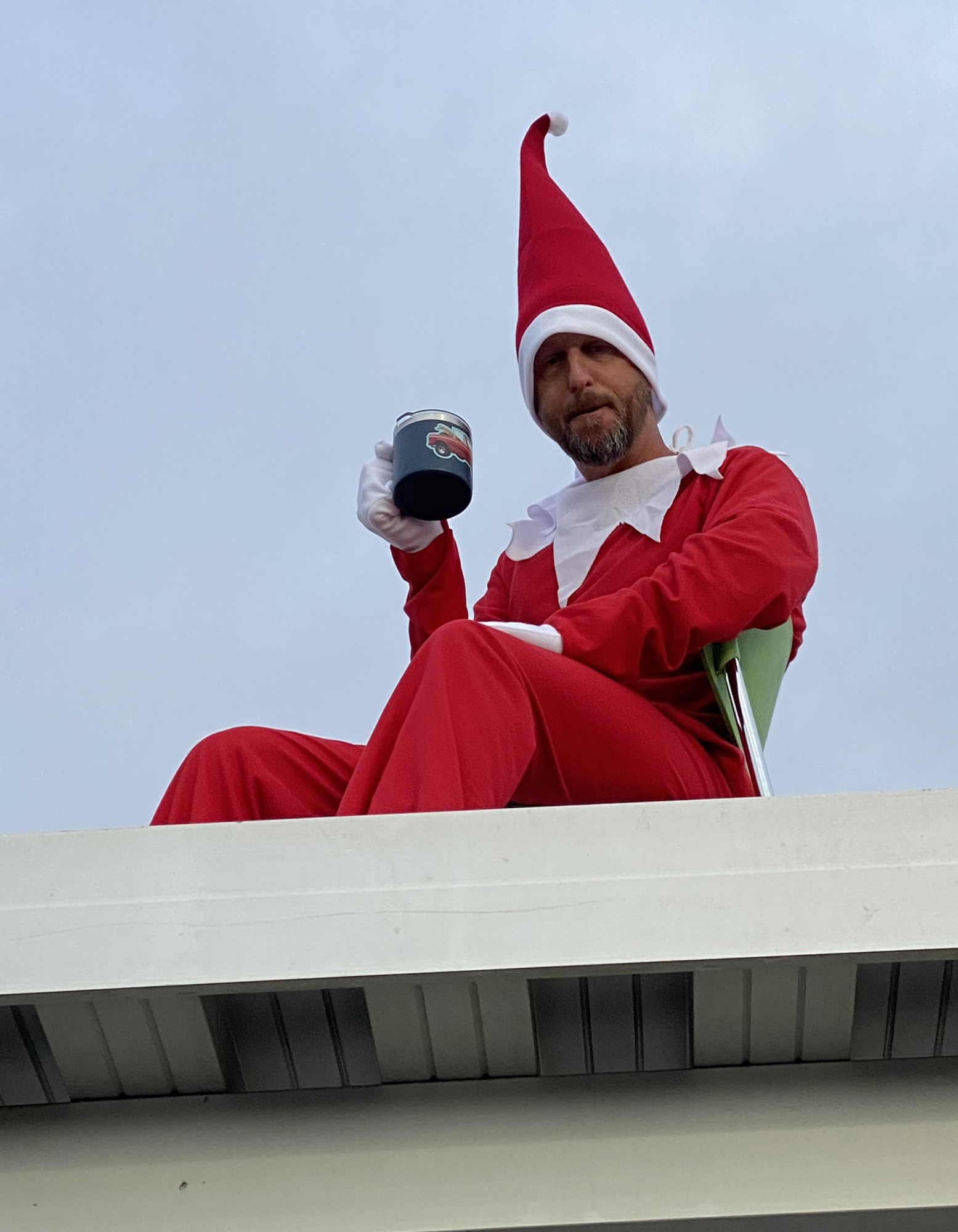 Principal Todd Richardson brings some fun to the holiday season by dressing as Elf on the Shelf and greeting students from the school's rooftop. Courtesy photo.