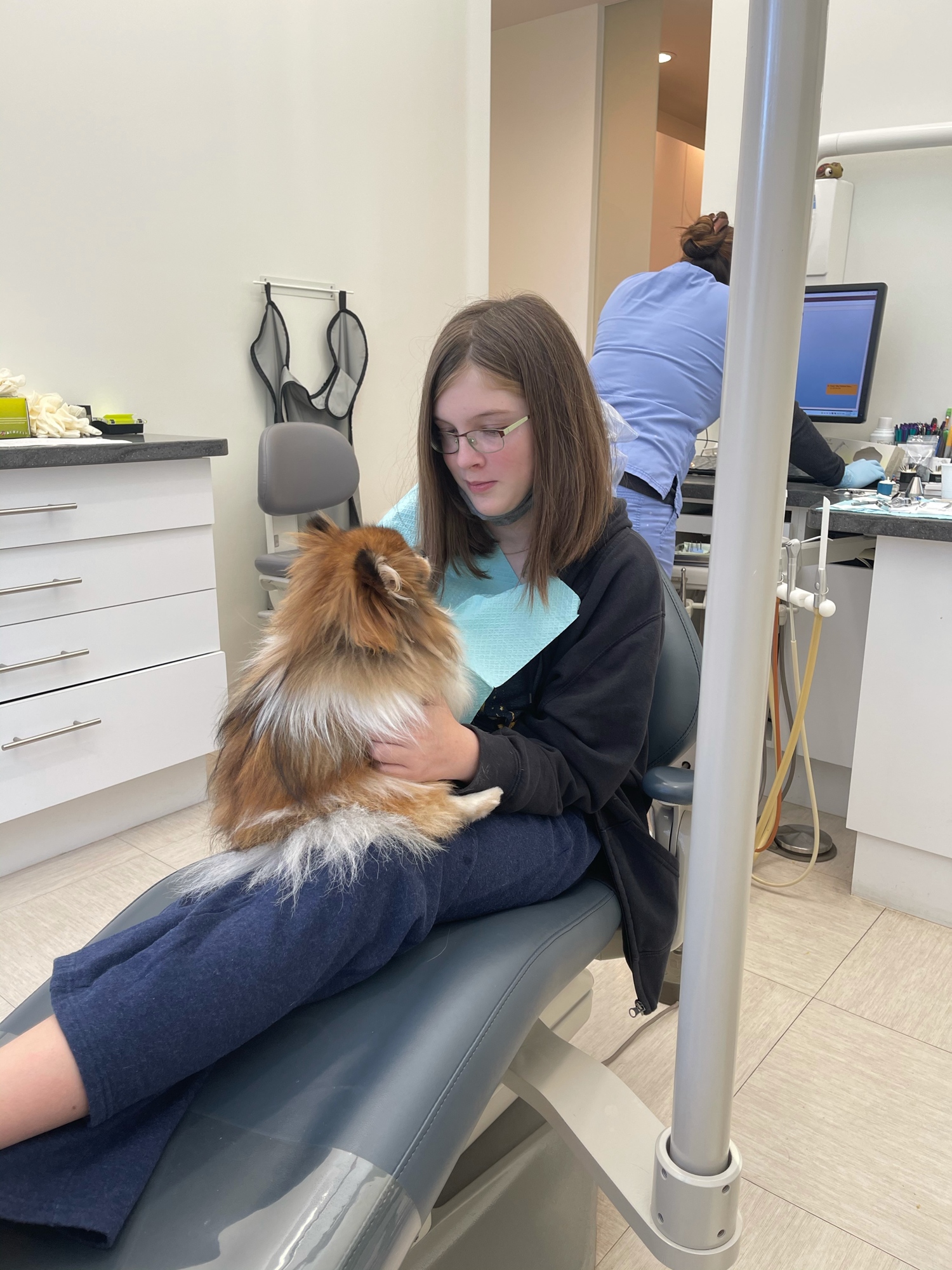 Allison Rothhaar pets a dog to help ease her anxiety about getting dental work done at Lakewood Ranch Endodontics.