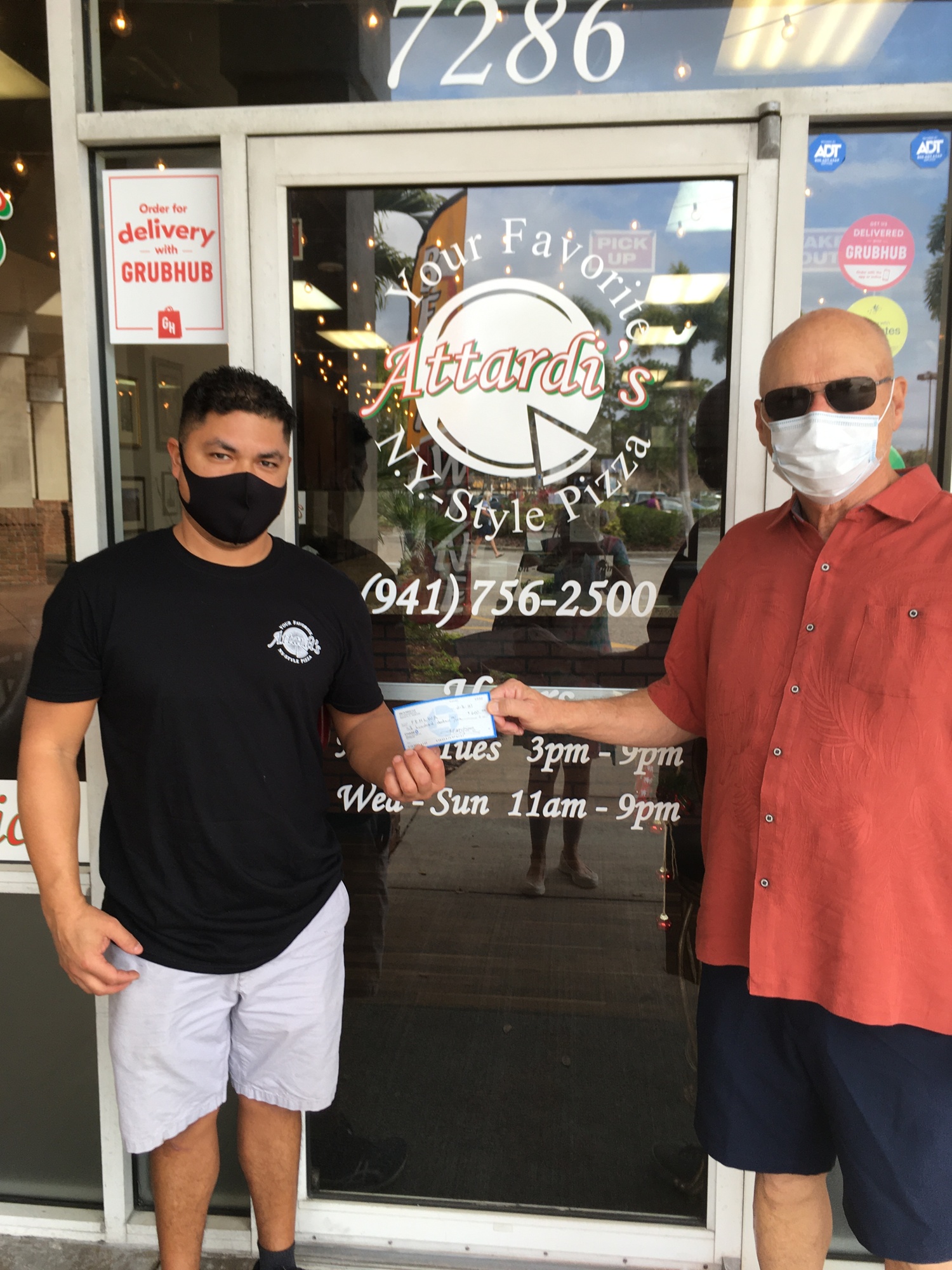 Attardi's Pizzeria Owner Mario DePaz hands a check to Friends of the East Manatee Library Treasurer Jim West after a Dine-Out Night. In addition to donating a portion of the proceeds, DePaz made a donation of his own. (Courtesy)