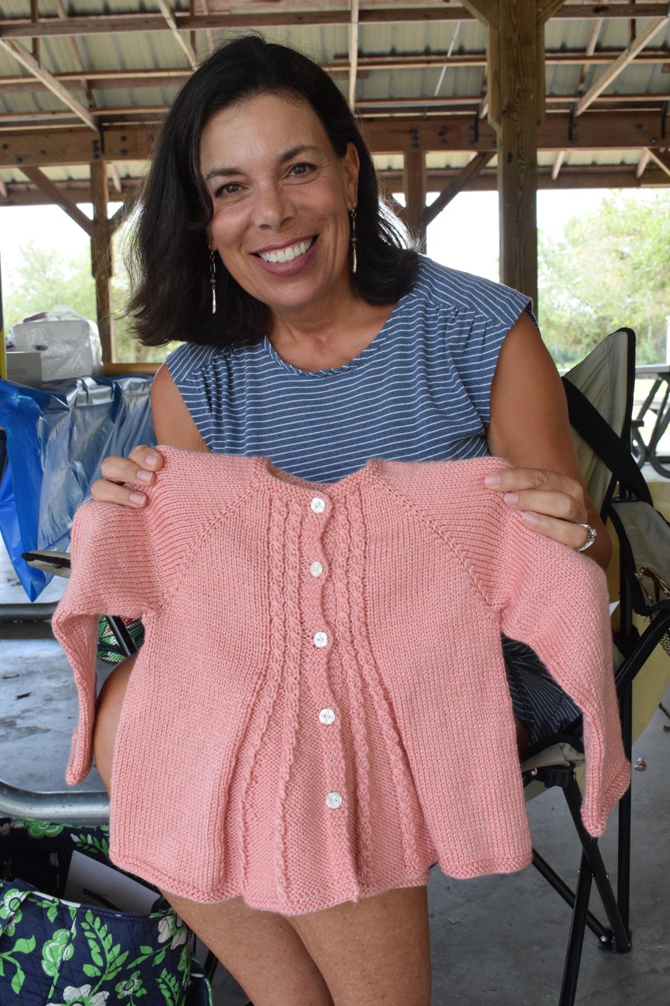 Lake Club's Jo Jadin shows the group the sweater she finished for her 5-year-old granddaughter.