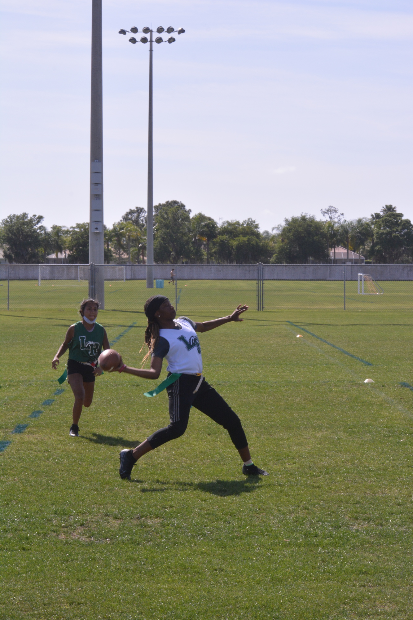 Kennedi Duncan launches a pass downfield while being pressured.