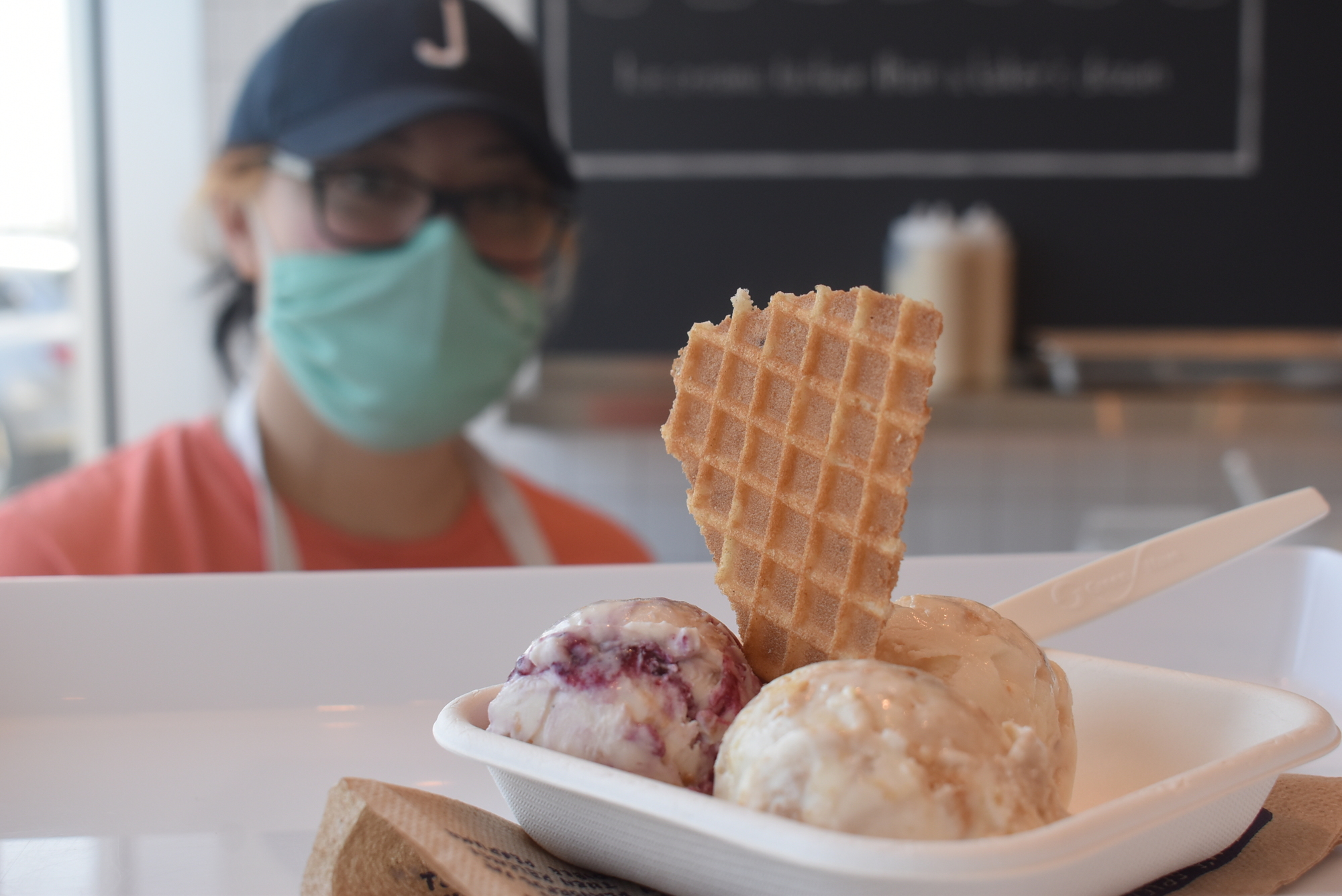 Jeni's Splendid Ice Creams Team Leader Kelly Barker serves an ice cream trio consisting of gooey butter cake, brambleberry crisp and brown butter almond brittle.