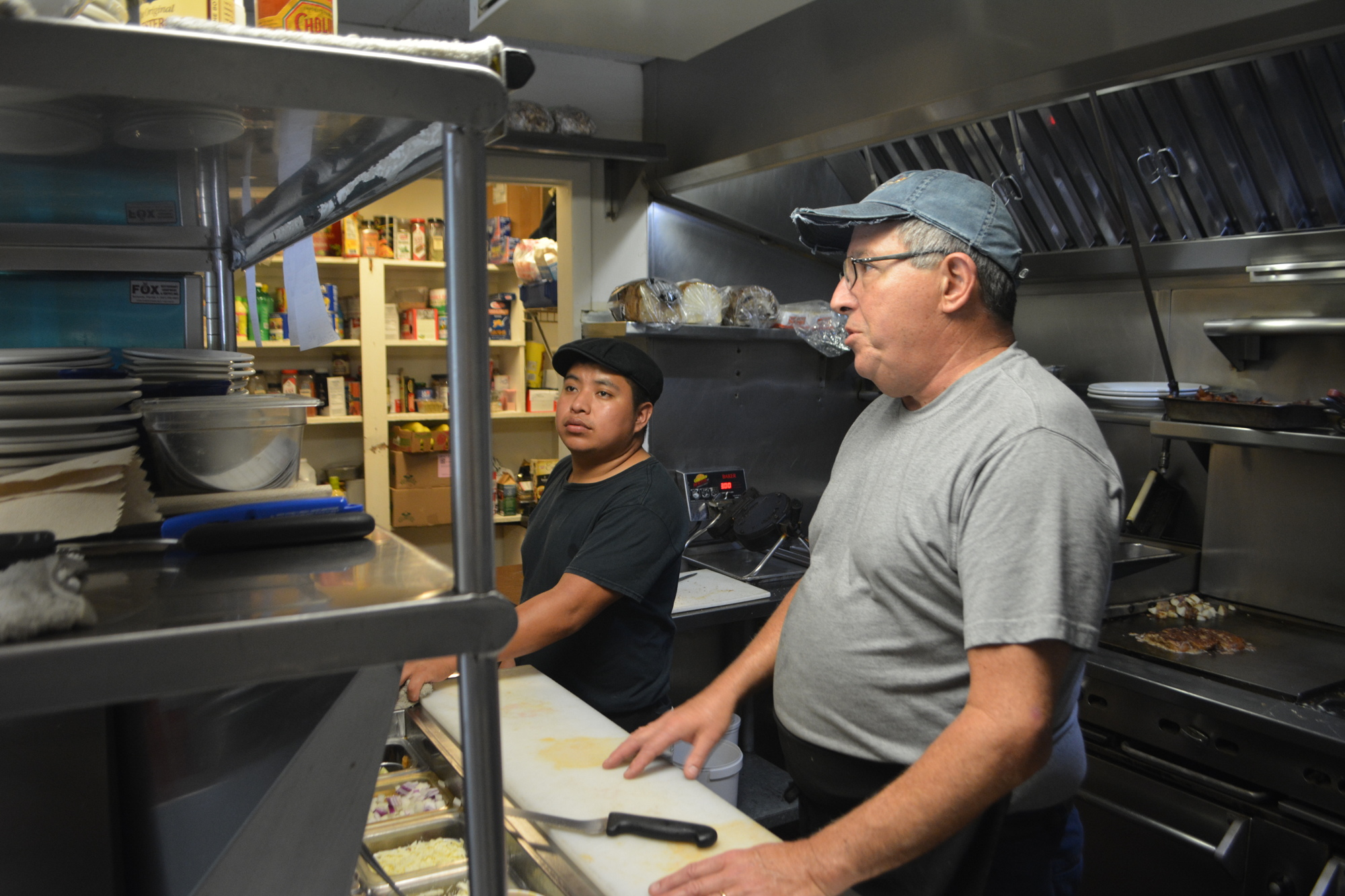 Jim Palermo, right, co-owner and chef at The Oasis Cafe, prepares breakfast for customers on Wednesday, April 14.