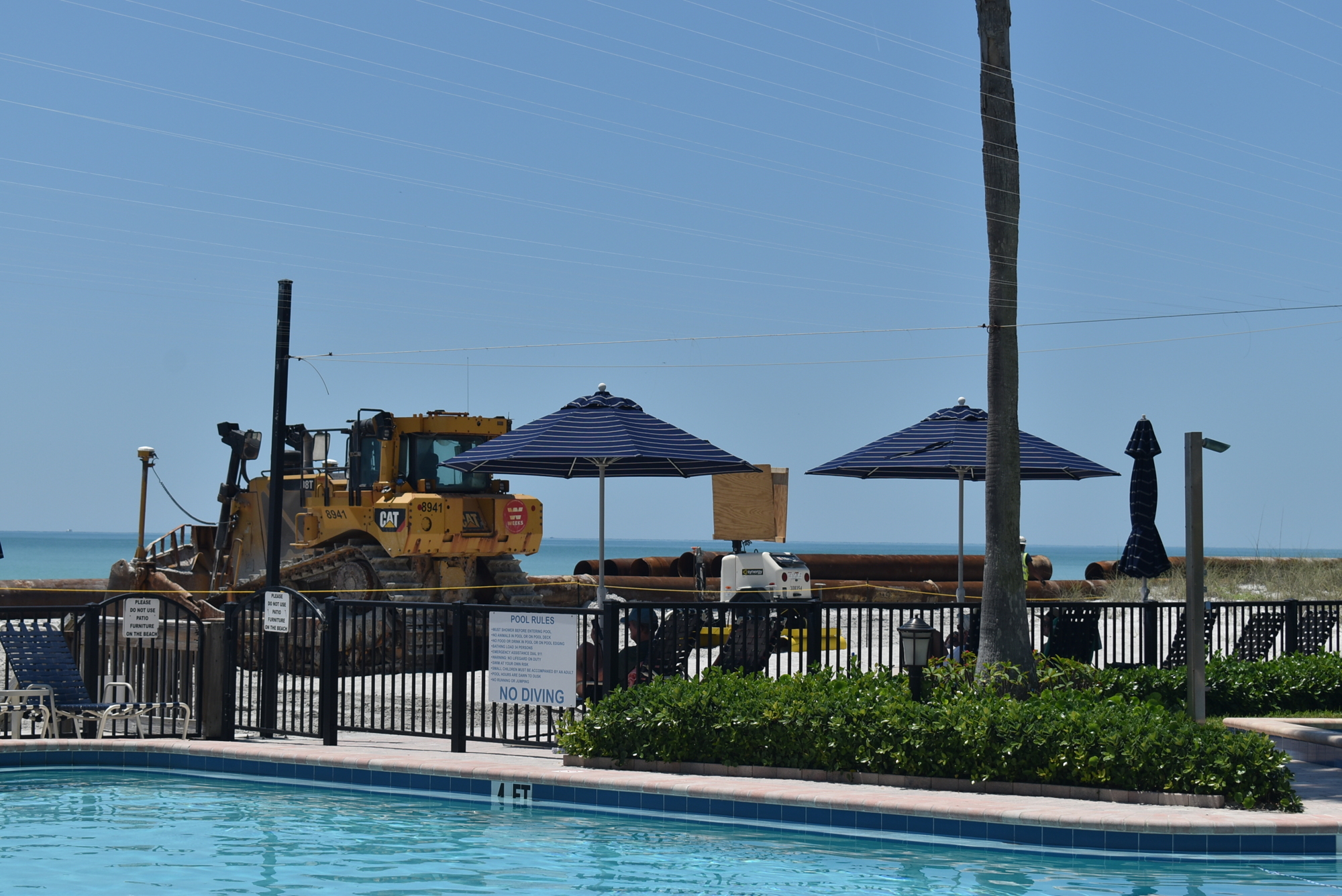 At Islands West, construction vehicles provide a different background than the typical gulf view.