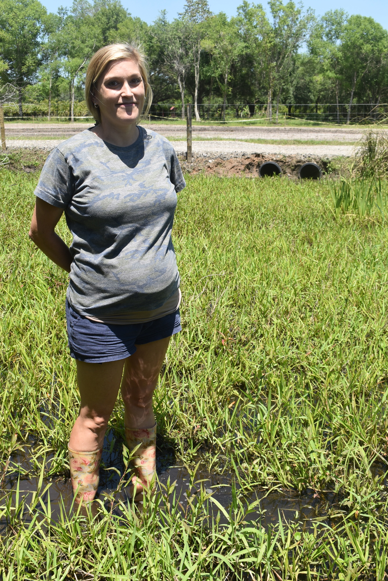 Amy Grosse, daughter of Doug Grosse, whose property borders the eastern side of the Mallaranny property, stands in water higher than ankle-deep caused by one day of rain. Grosse said this didn't happen in the past.