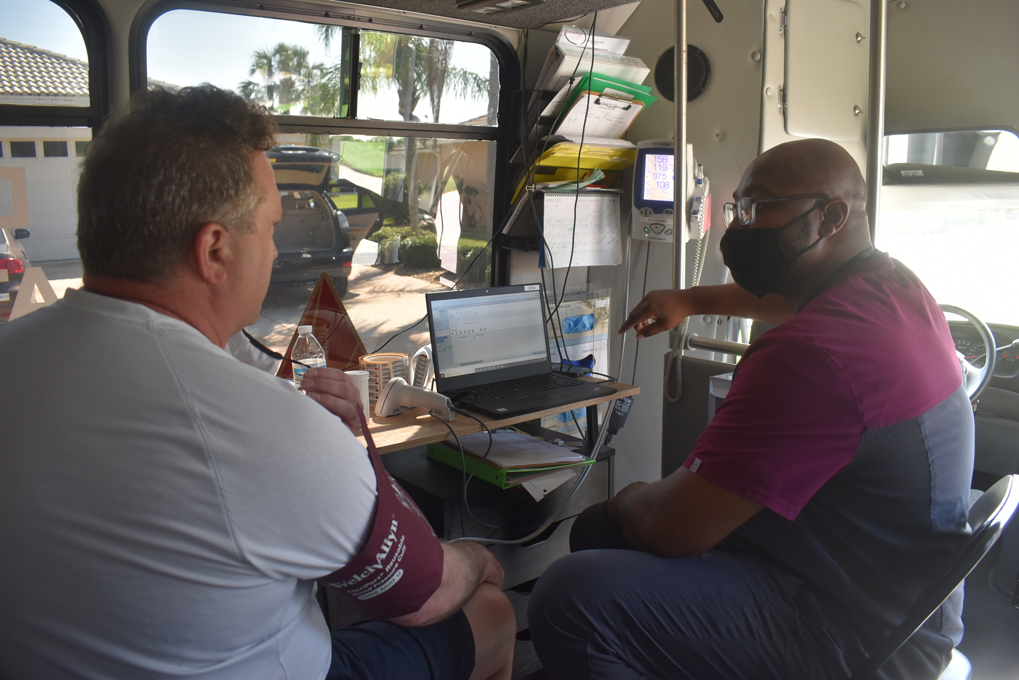 Parrish resident Daniel Wansten listens to SunCoast Blood Centers Technician Ryan Milner as he explains when he can come back for a second appointment.