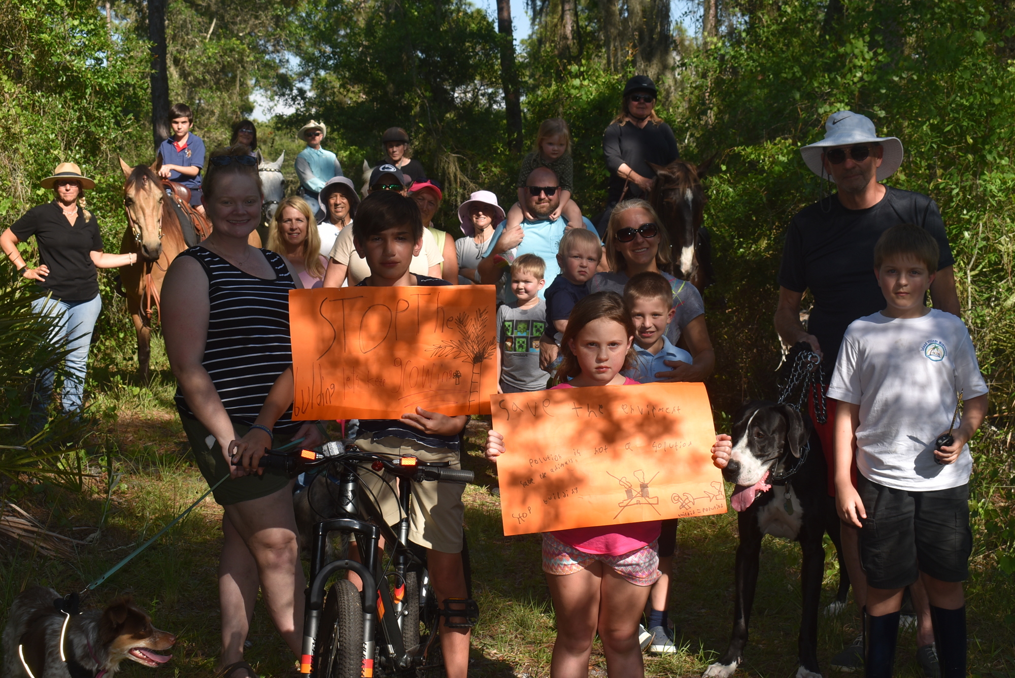 Cyclists, horseback riders and others from Panther Ridge and the Concession show their opposition to a land use amendment that would add 15 single-family homes near the entrance to the Concession.